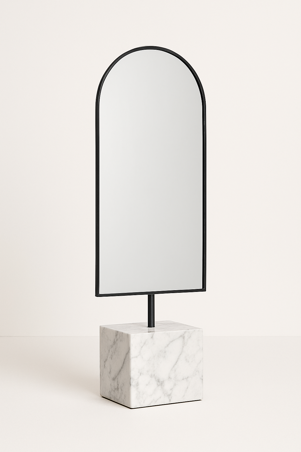 A tall, arched mirror with a black frame, mounted on a white marble base, set against a plain light background.