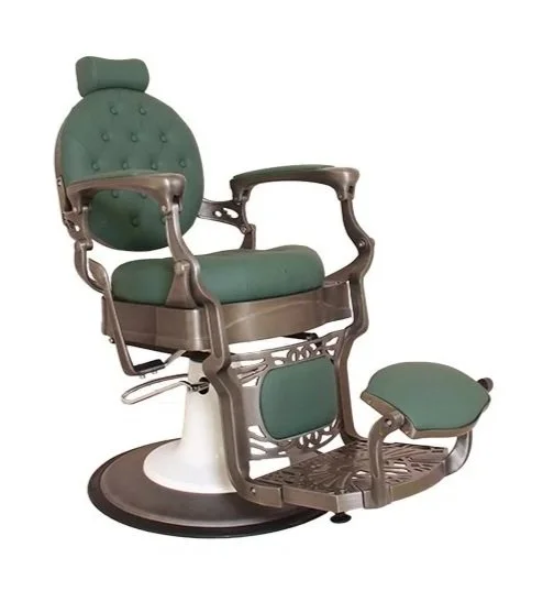 Antique barber chair with green upholstery and a matching footrest.