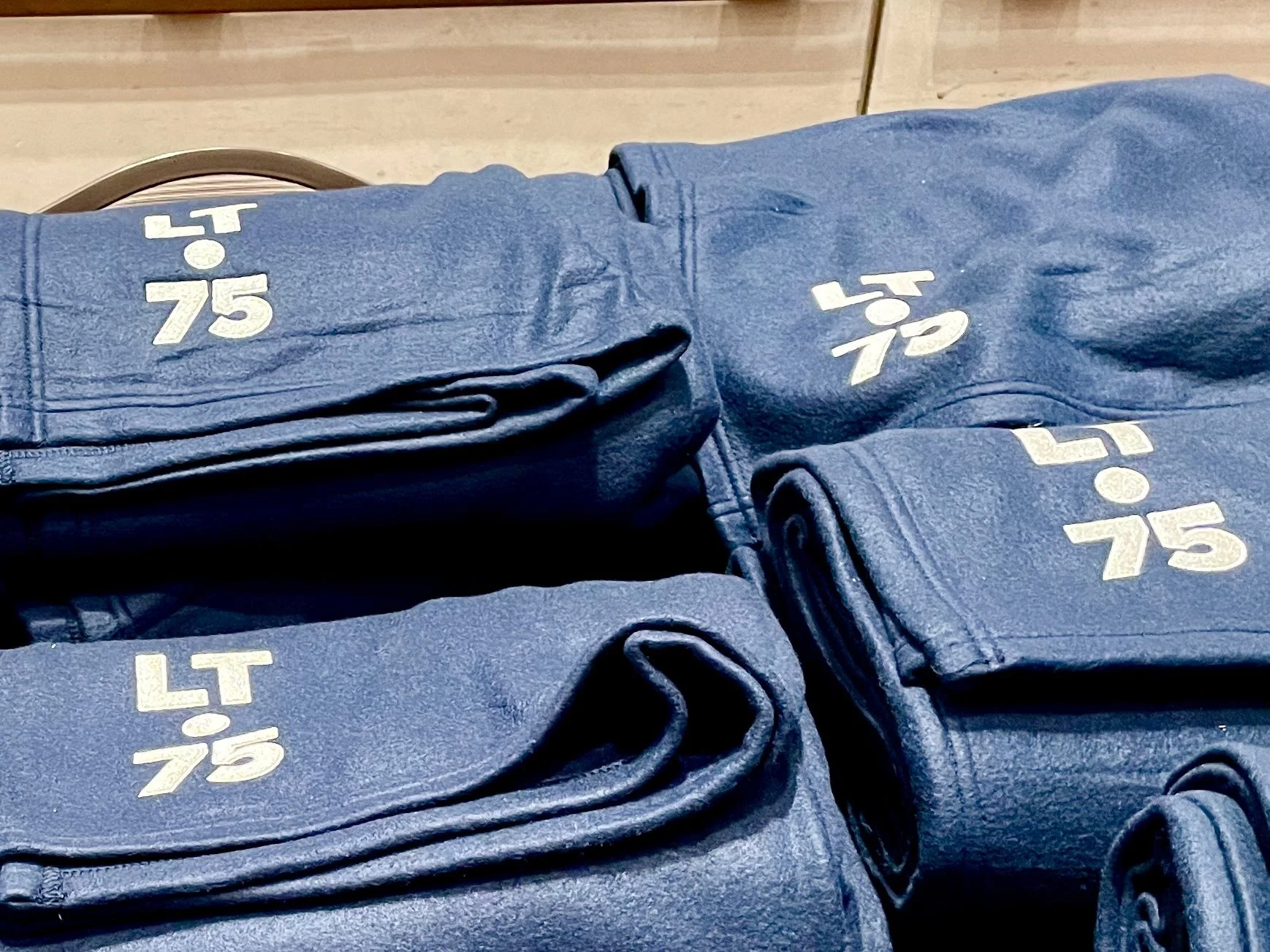 Stack of blue LT 75 branded blankets