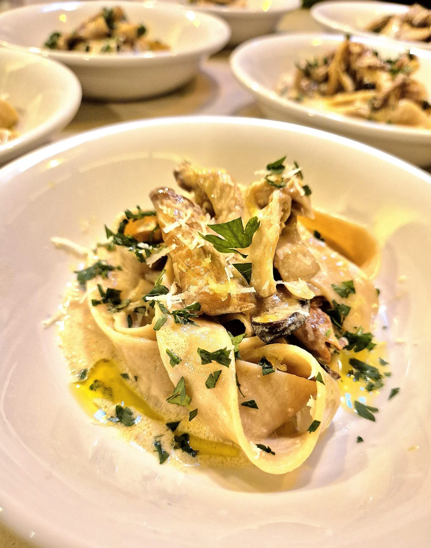 Plate of pasta with creamy sauce, garnished with chopped parsley.