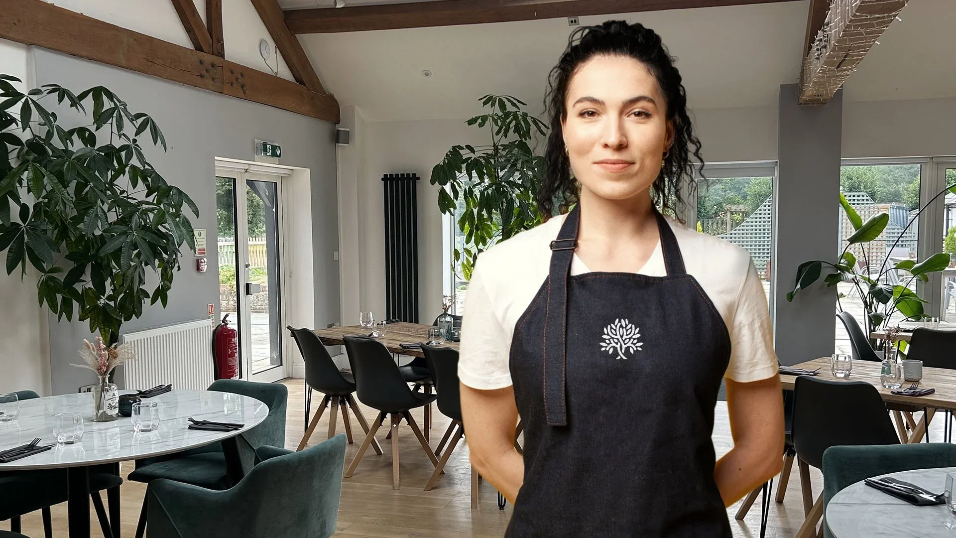 waitress in colin nash restaurant wearing logo apron designed by saia creative