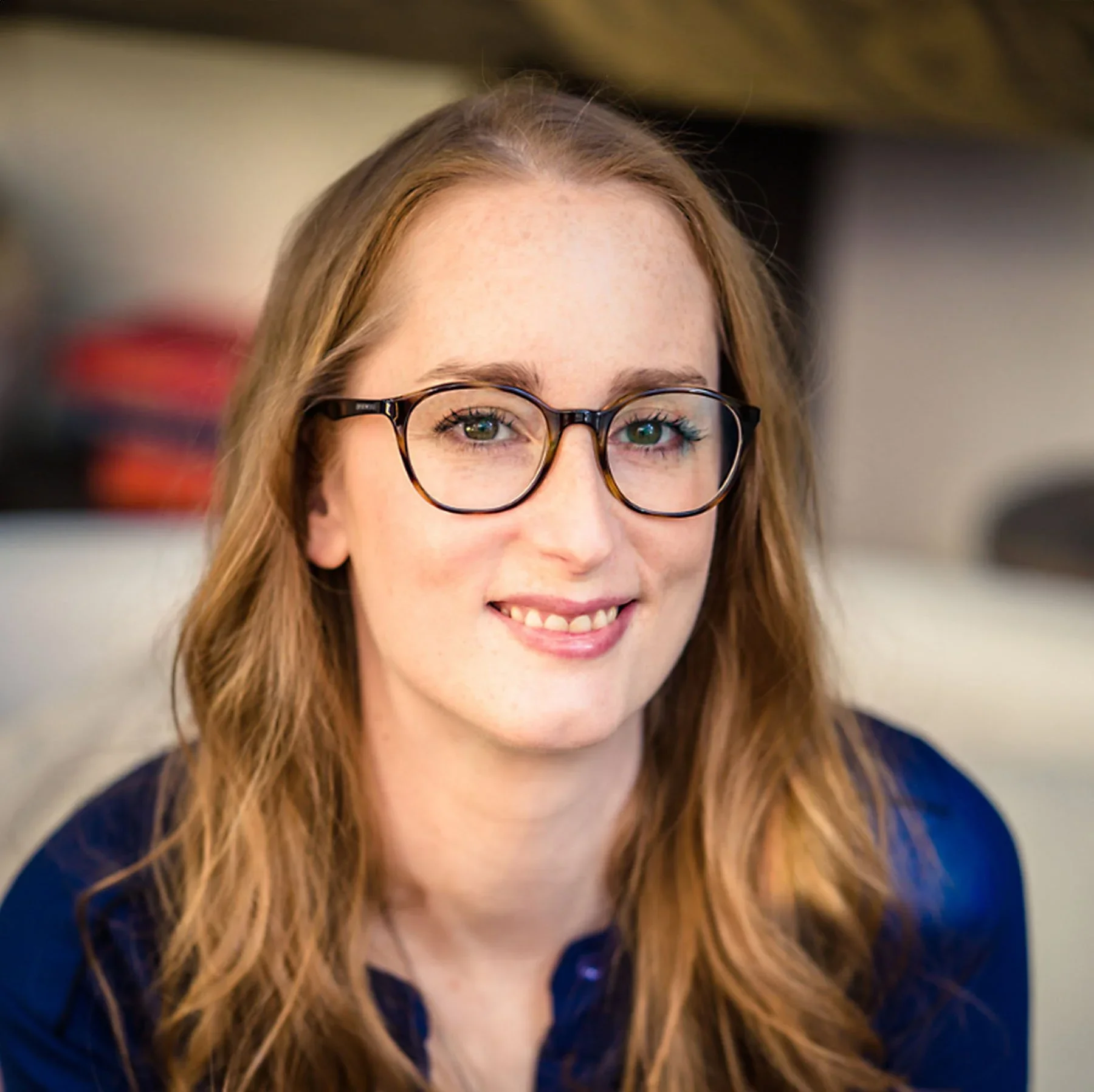 Helen Munshi wearing glasses in a close up professional headshot.