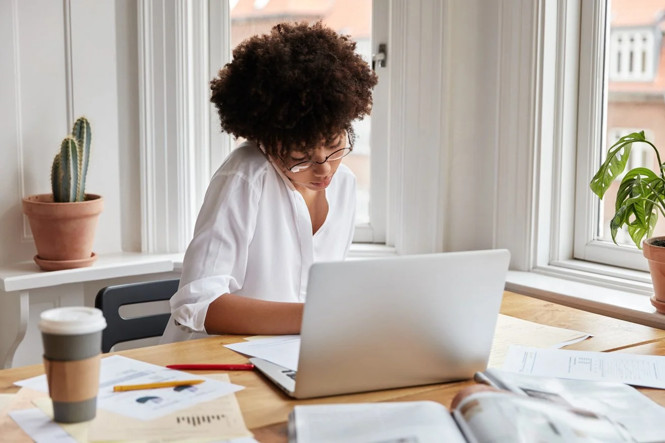 A small business owner reviewing their marketing strategy at a desk.