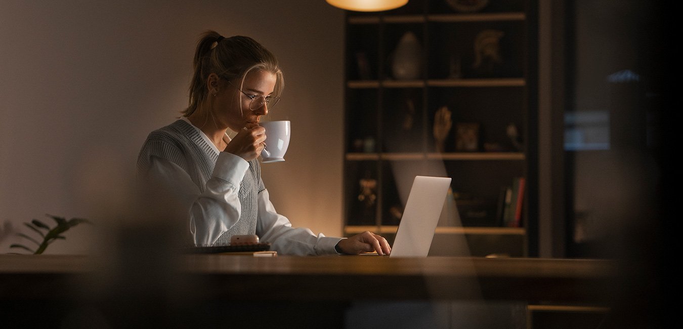 Founder managing multiple marketing tasks alone on laptop, showing overwhelm.
