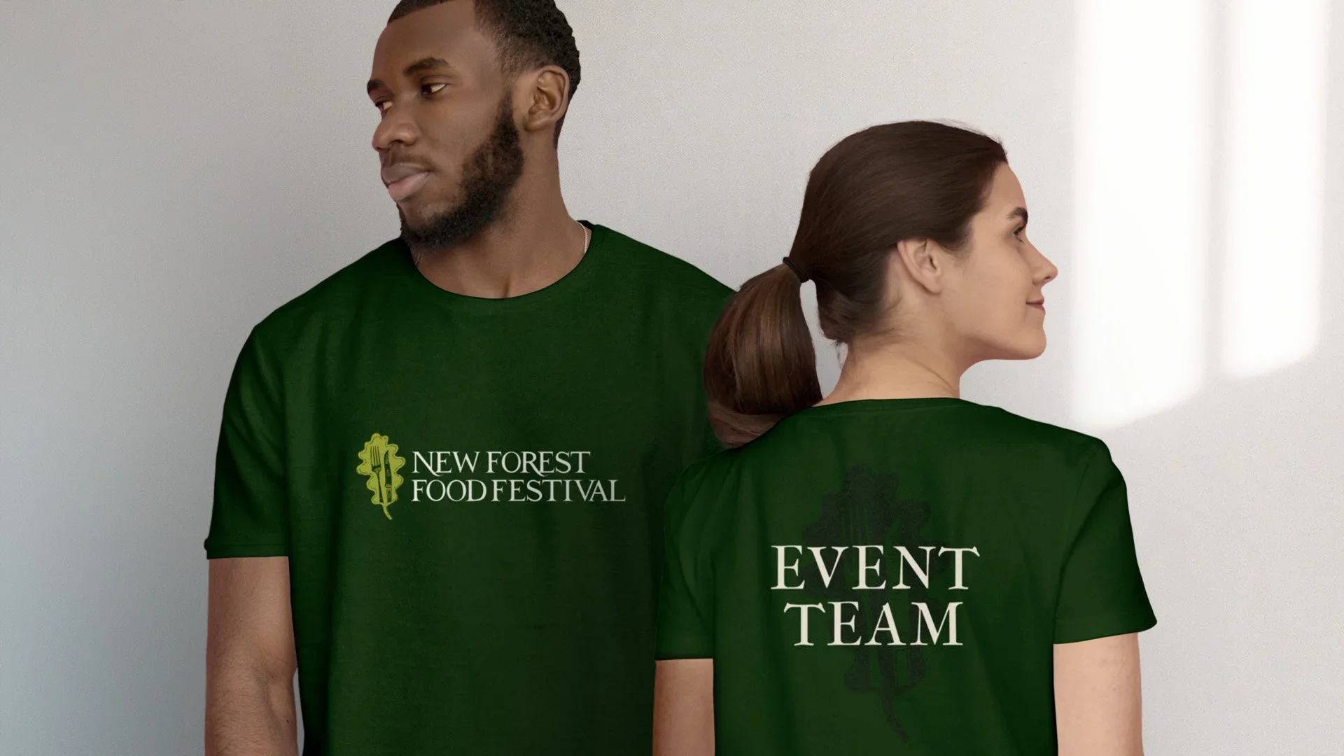 man woman wearing festival event team t shirts designed by saia creative