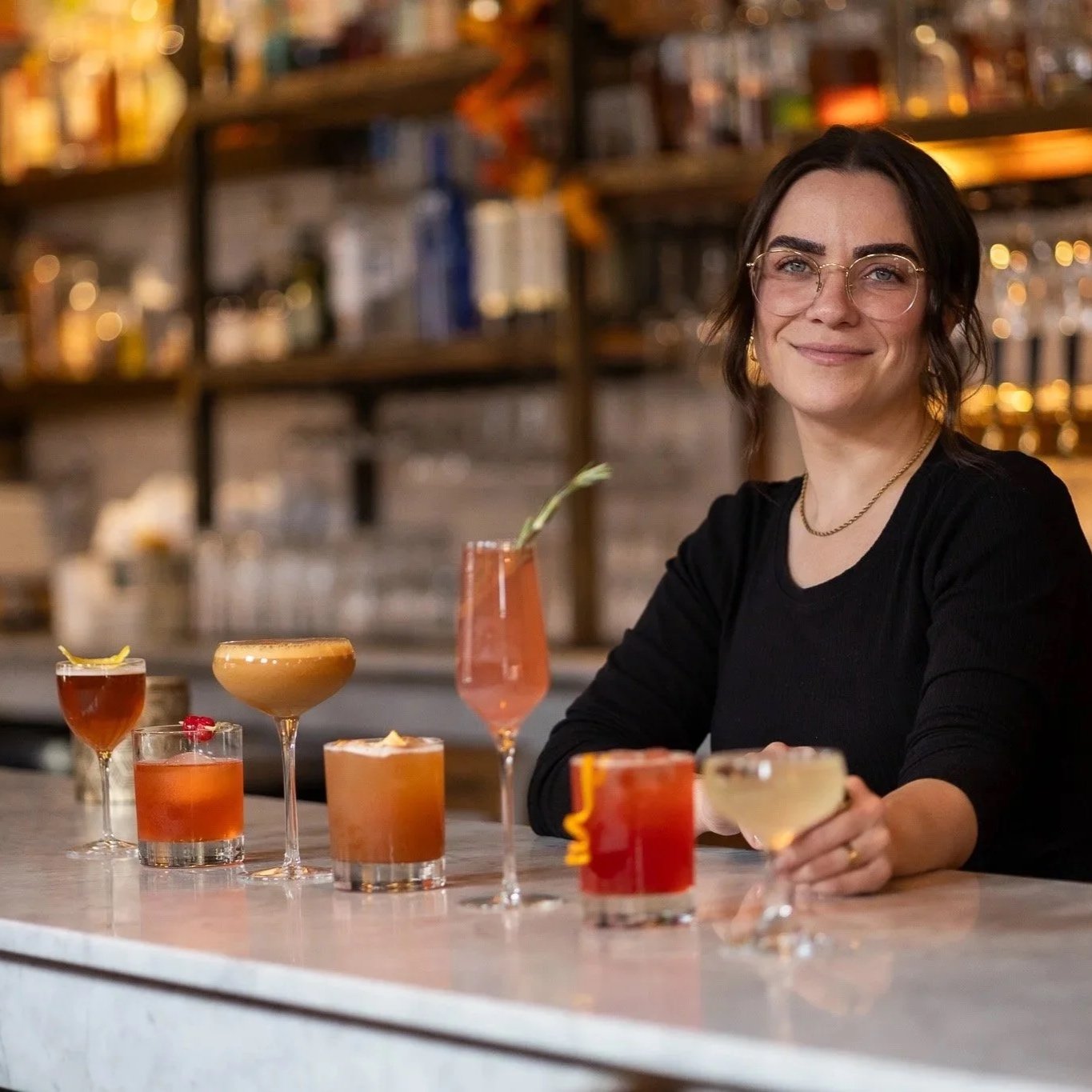Bartender presenting handcrafted cocktails at South Village Grille in German Village, Columbus, Ohio.