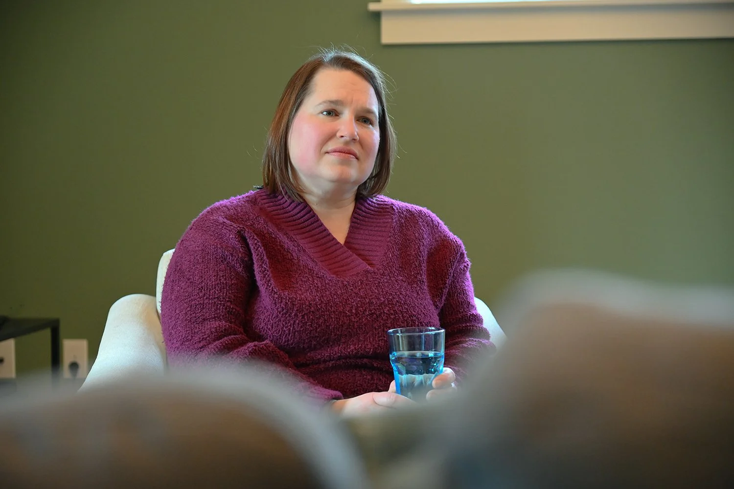 Alison compassionately sitting with someone in active dying stage