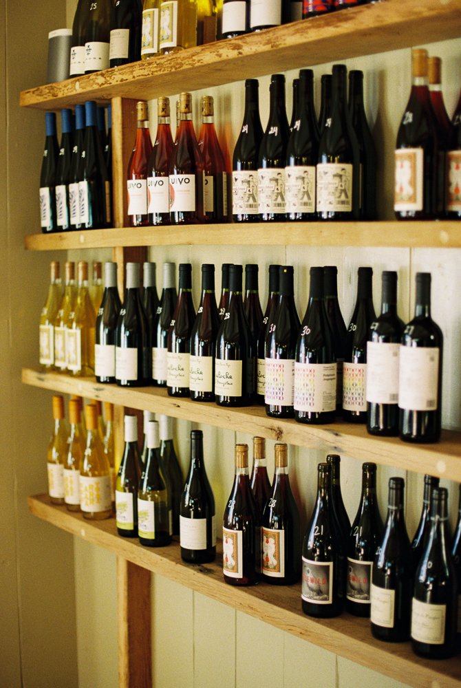 Wall shelves inside From the Well filled with organic, biodynamic wines for sale