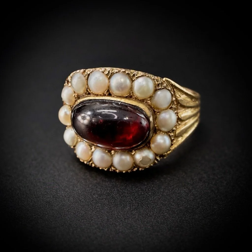 Antique garnet &amp; pearl mourning ring, c. 1845.
Rich cabochon garnet surrounded by a halo of natural pearls, set in 15k gold.
A deeply sentimental Victorian piece with an engraved interior&mdash;made to be worn, remembered, and passed on.

Now lis