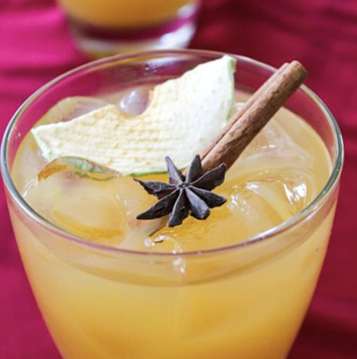 Orange cocktail with cinnamon, star anise, and melon — crafted by private chef.