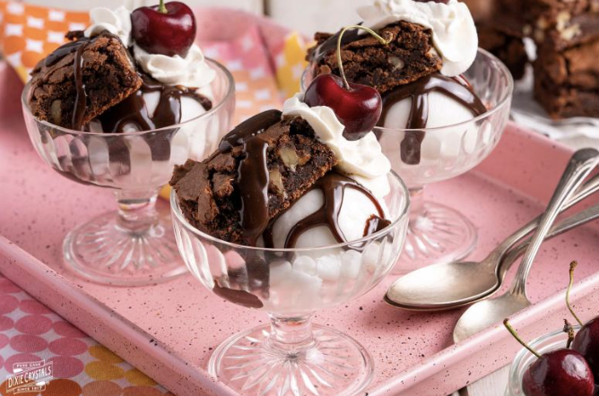 Chocolate brownie sundaes with whipped cream and cherries — private chef dessert.