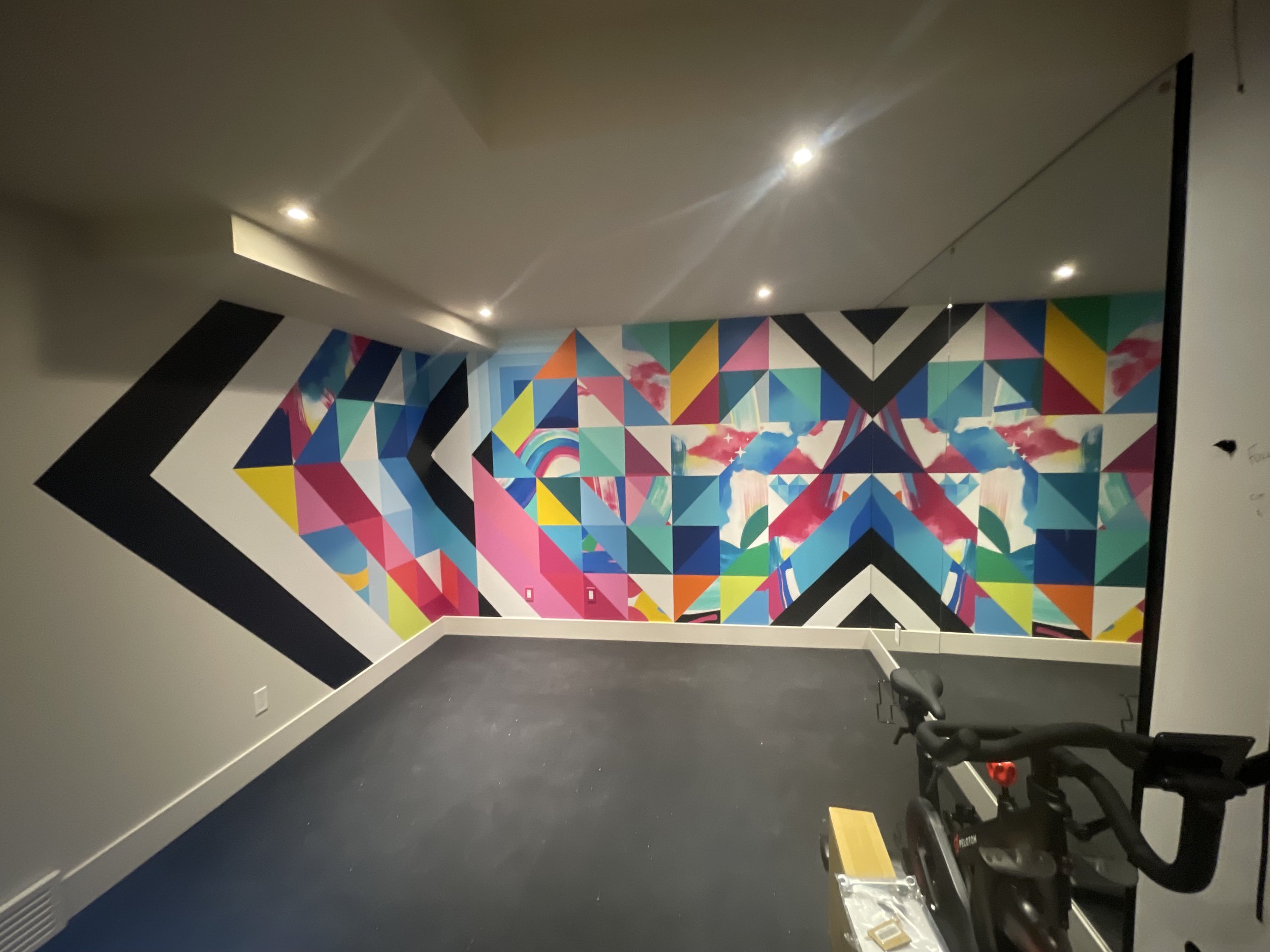 A mural in a home gym Calgary, AB with custom light fixtures.