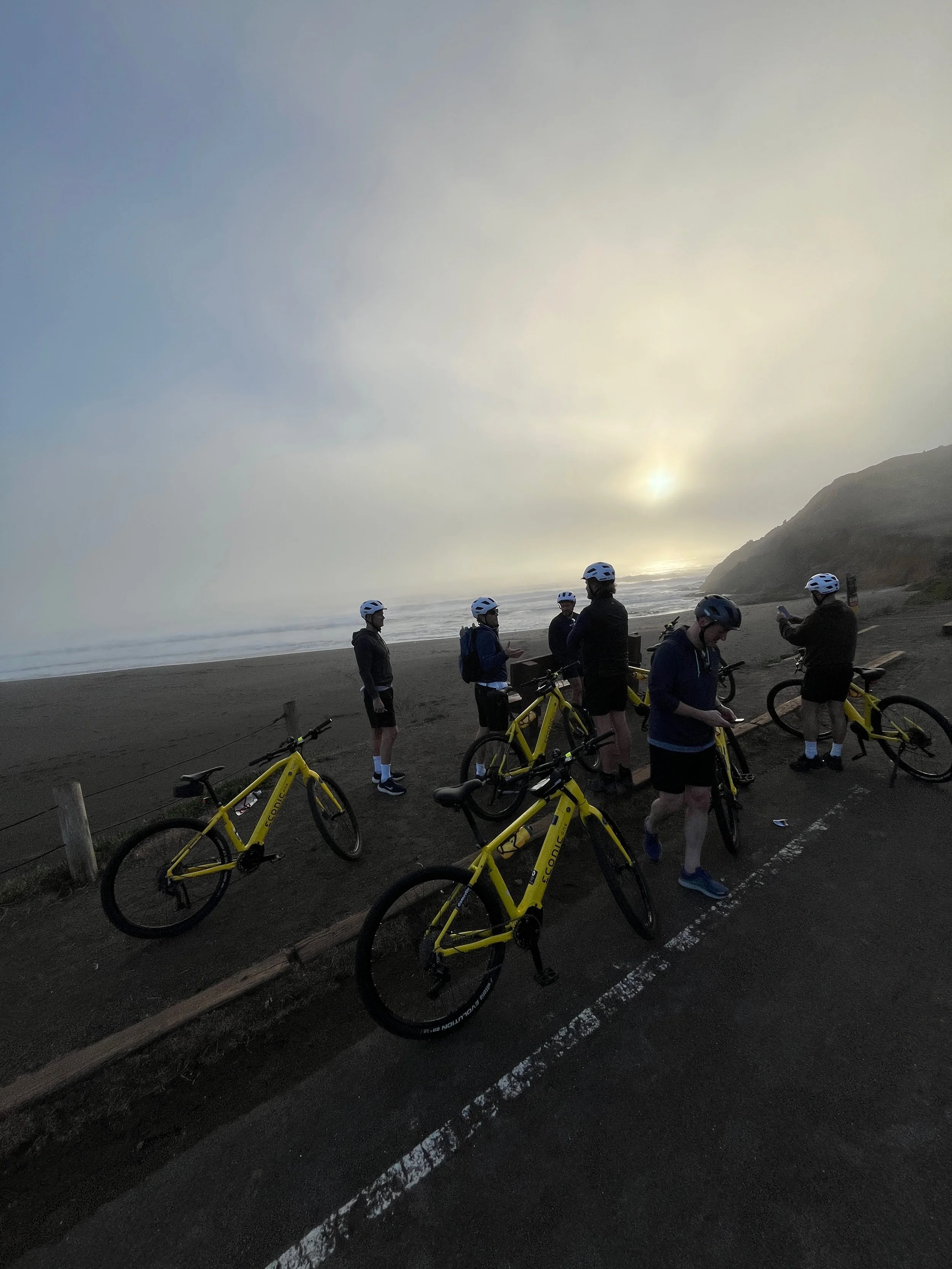 Fog surrounding happy riders at Rodeo Beach in the Marin Headlands