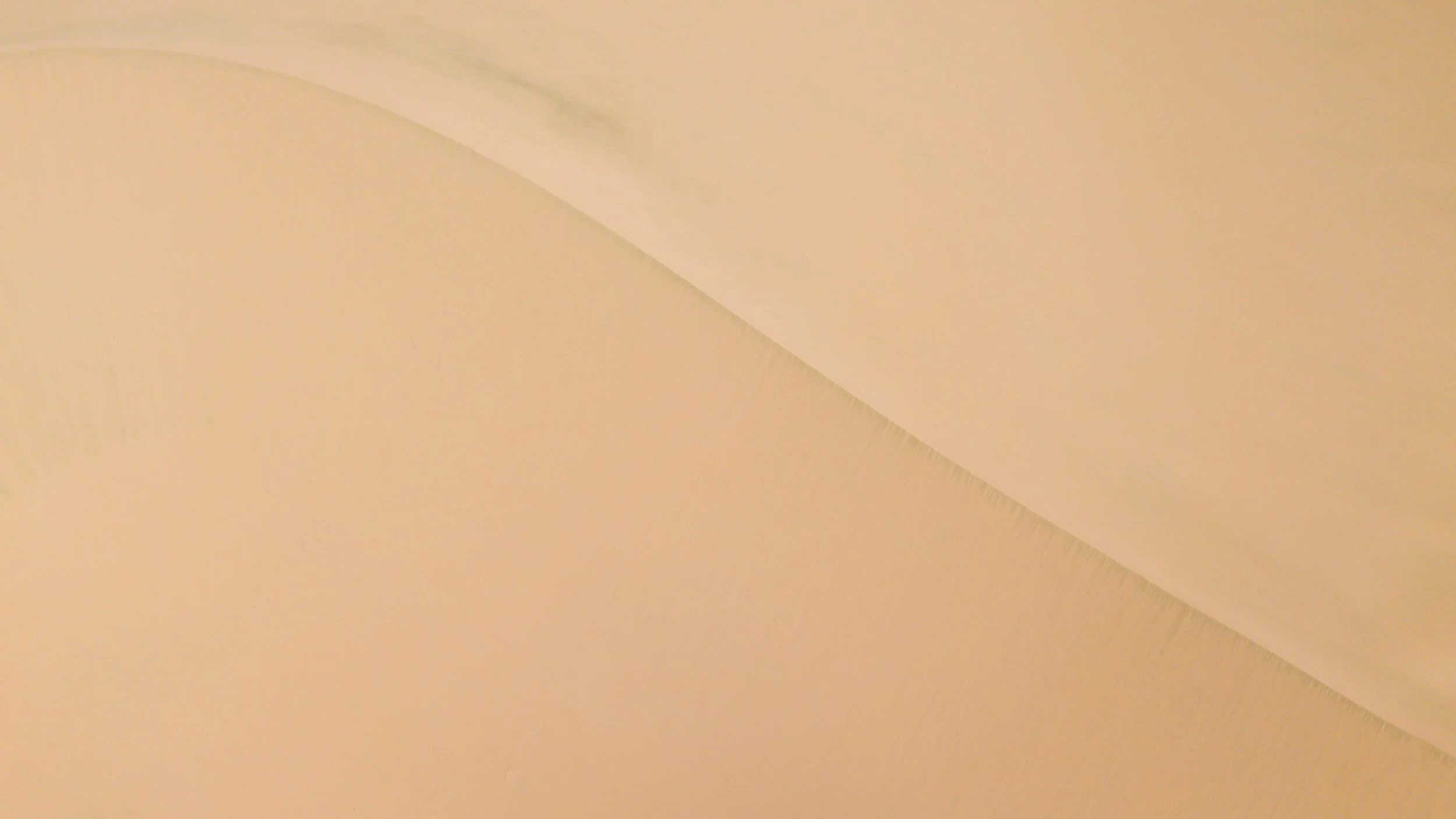 Jonah wanted a line in the sand to keep others out. God drew a circle and included all people. Here, a picture is taken of a sand dune from high above. The top of the dune cuts a line through the landscape.