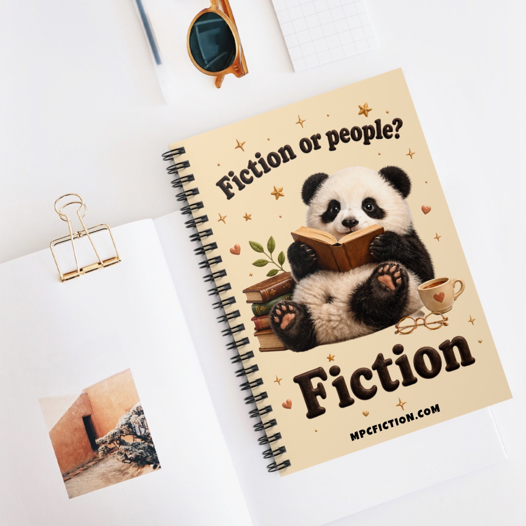 Spiral notebook featuring a cozy panda reading a book with the quip Fiction or People — a funny bookish gift for book lovers and readers by Michael P. Clutton.
