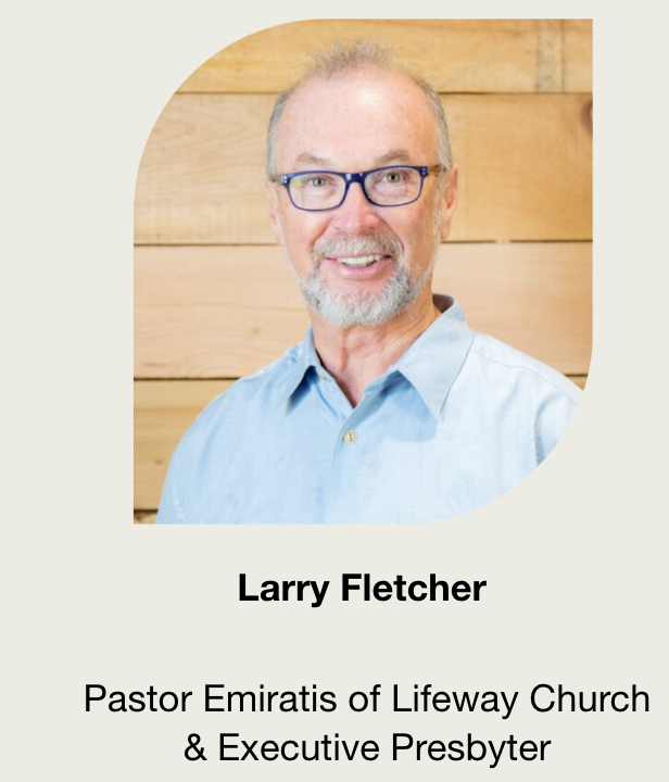Headshot of Larry Fletcher, a man with gray hair, glasses, and a beard, wearing a light blue collared shirt, smiling in front of a wooden wall background.