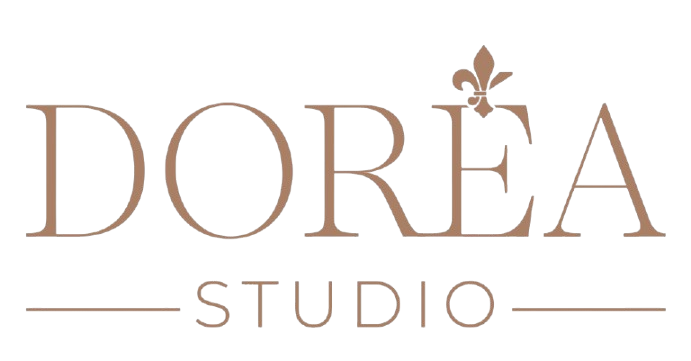 Logo for Dore'a Studio featuring elegant text and a small decorative fleur-de-lis above the letter 'E'.
