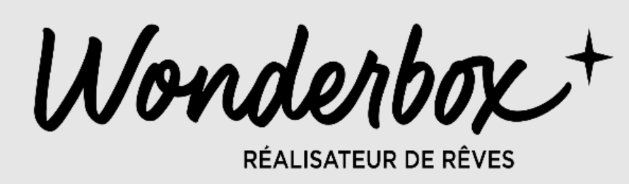 Logo avec le mot 'Wonderbox' en script noir, une étoile à côté, et la phrase 'RÉalisateur DE RÊVES' en dessous sur un fond gris clair.