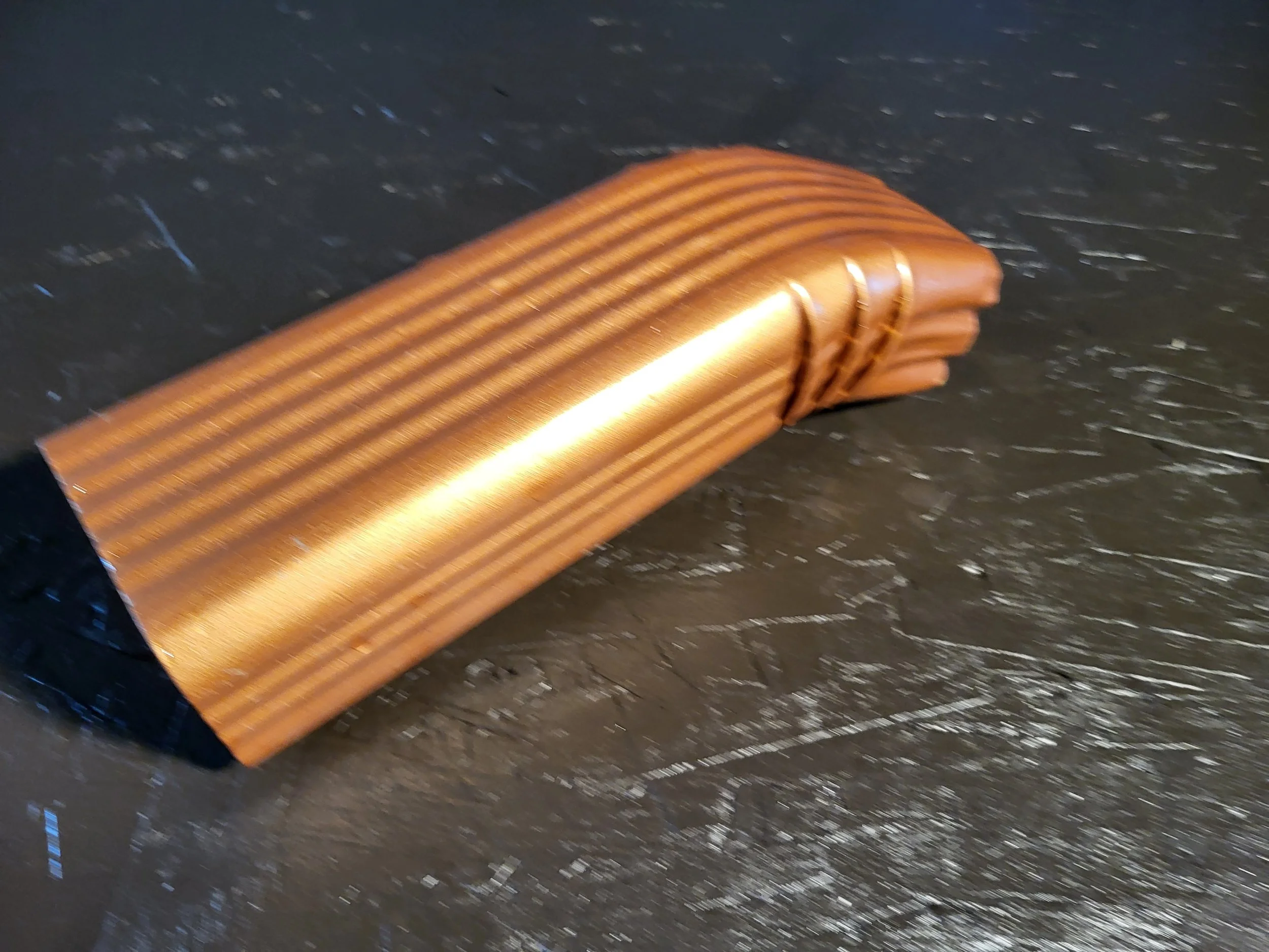 Close-up of a downspout offset in copper penny