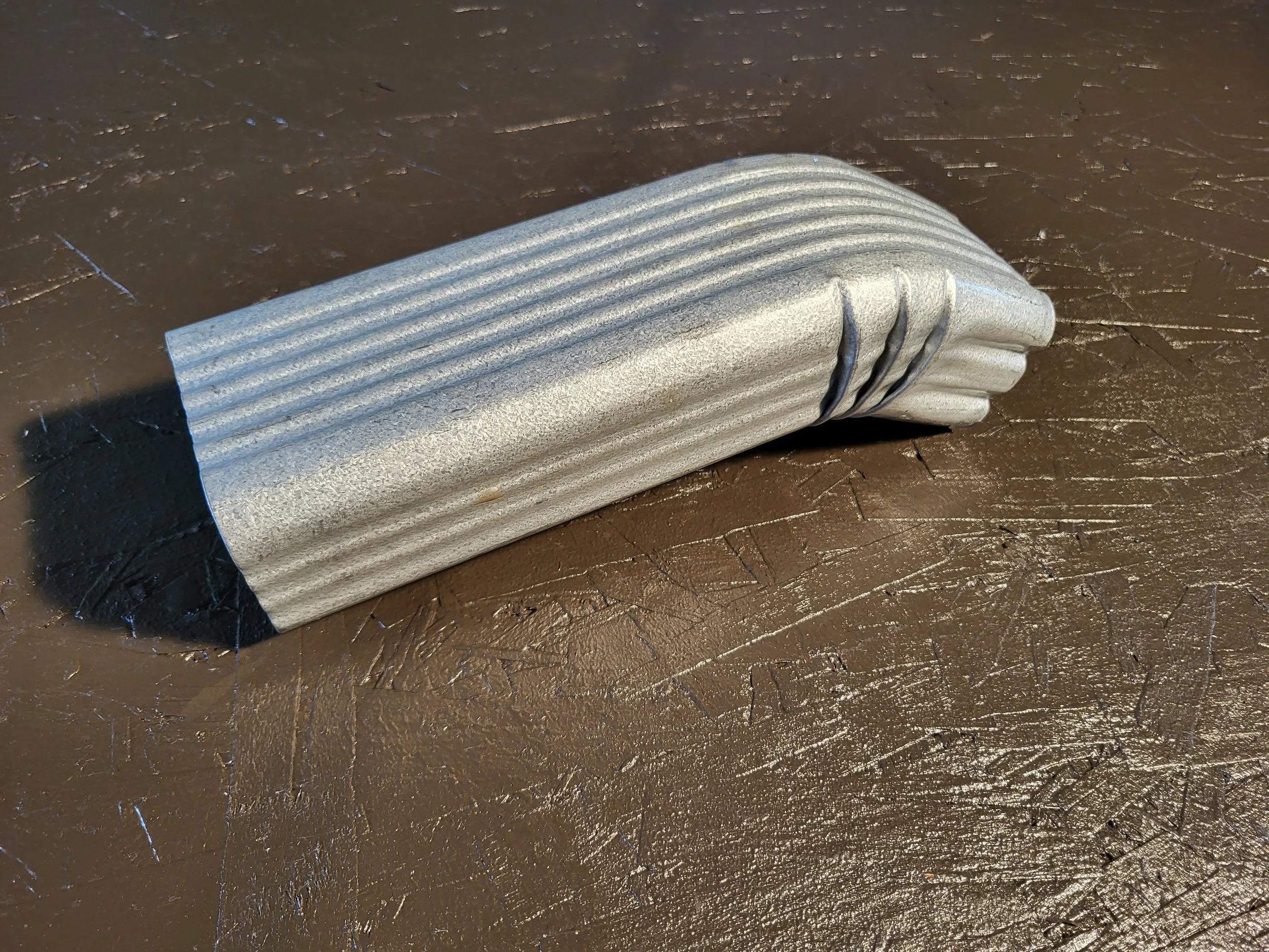 close-up of a downspout offset in galvanized