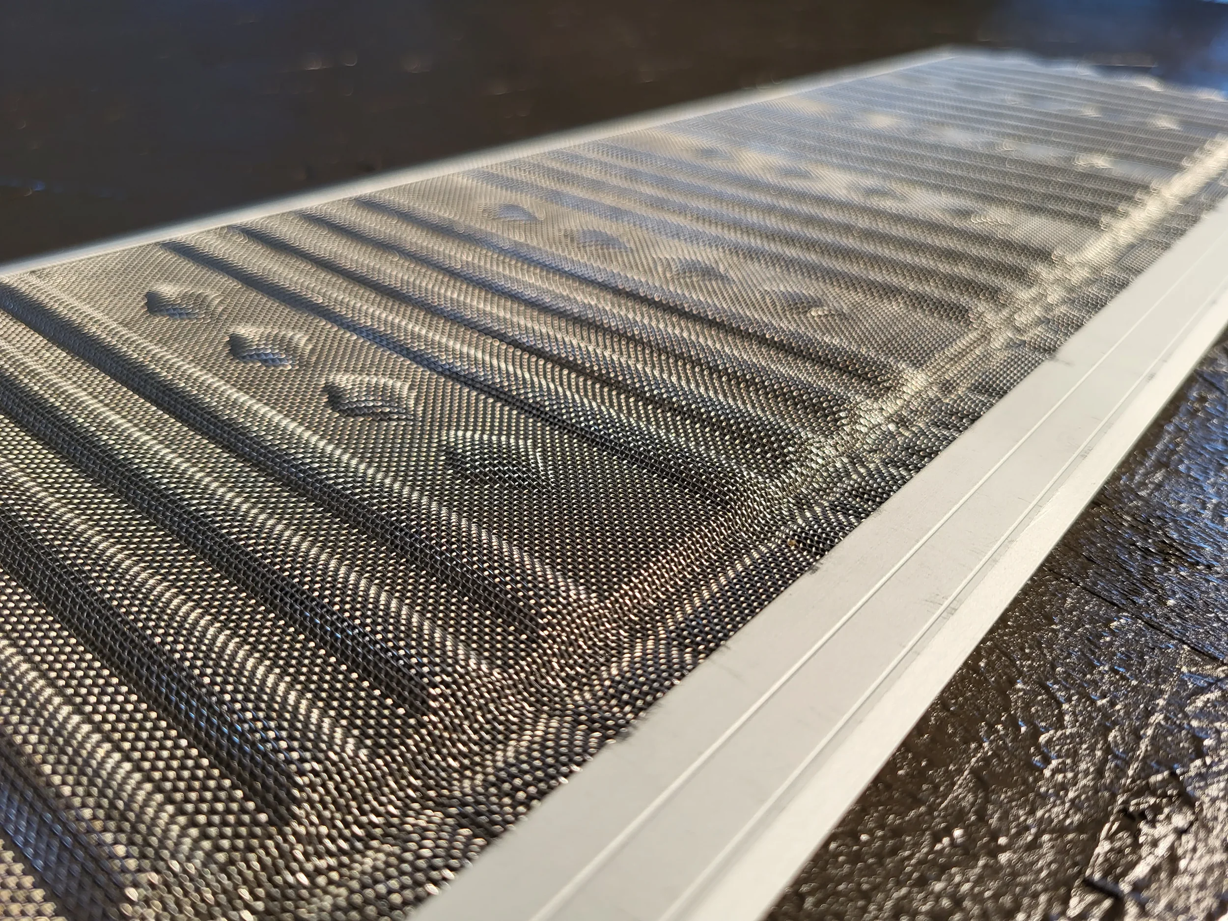 Close-up of a stainless steel mesh gutter guard