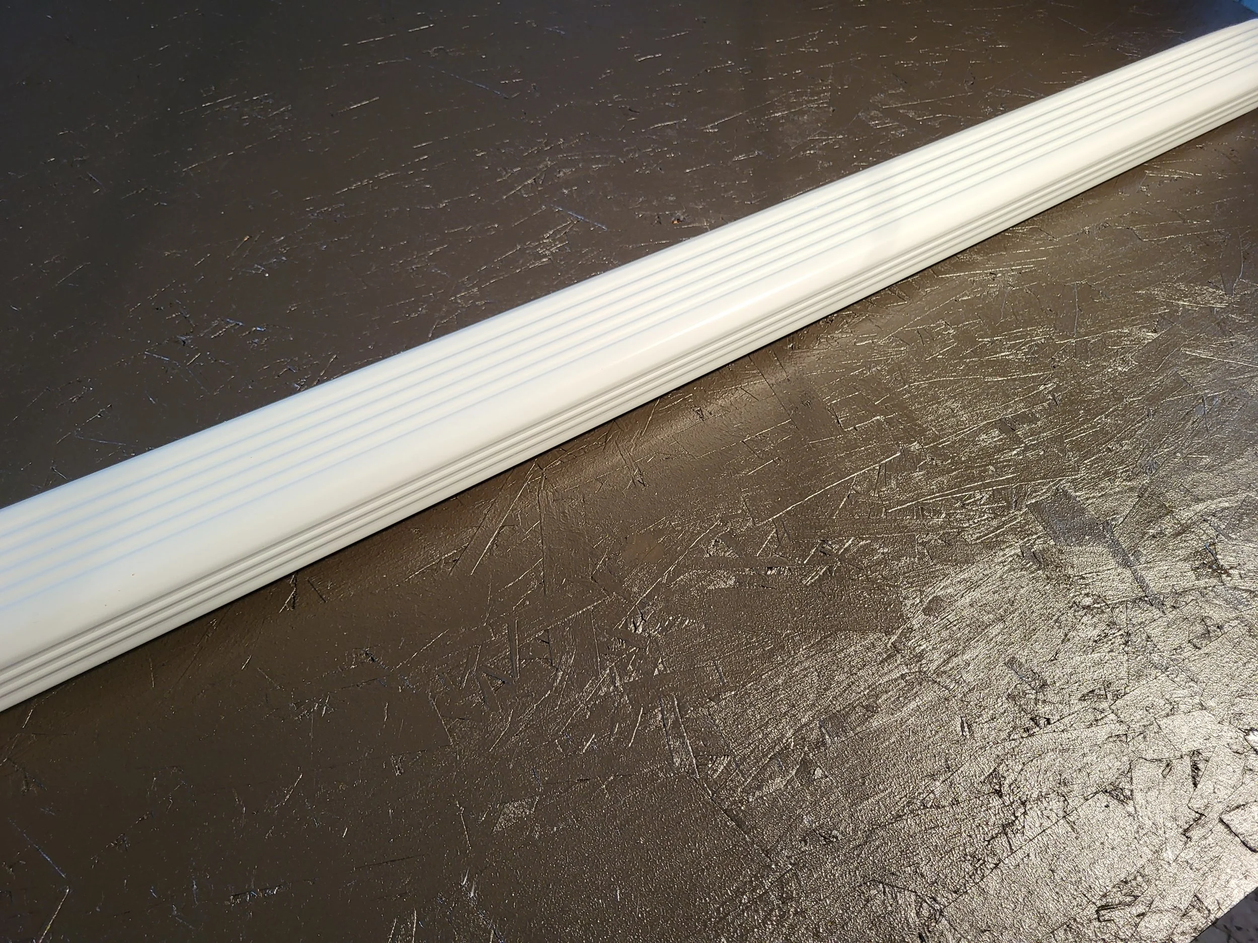 A long white corrugated downspout.