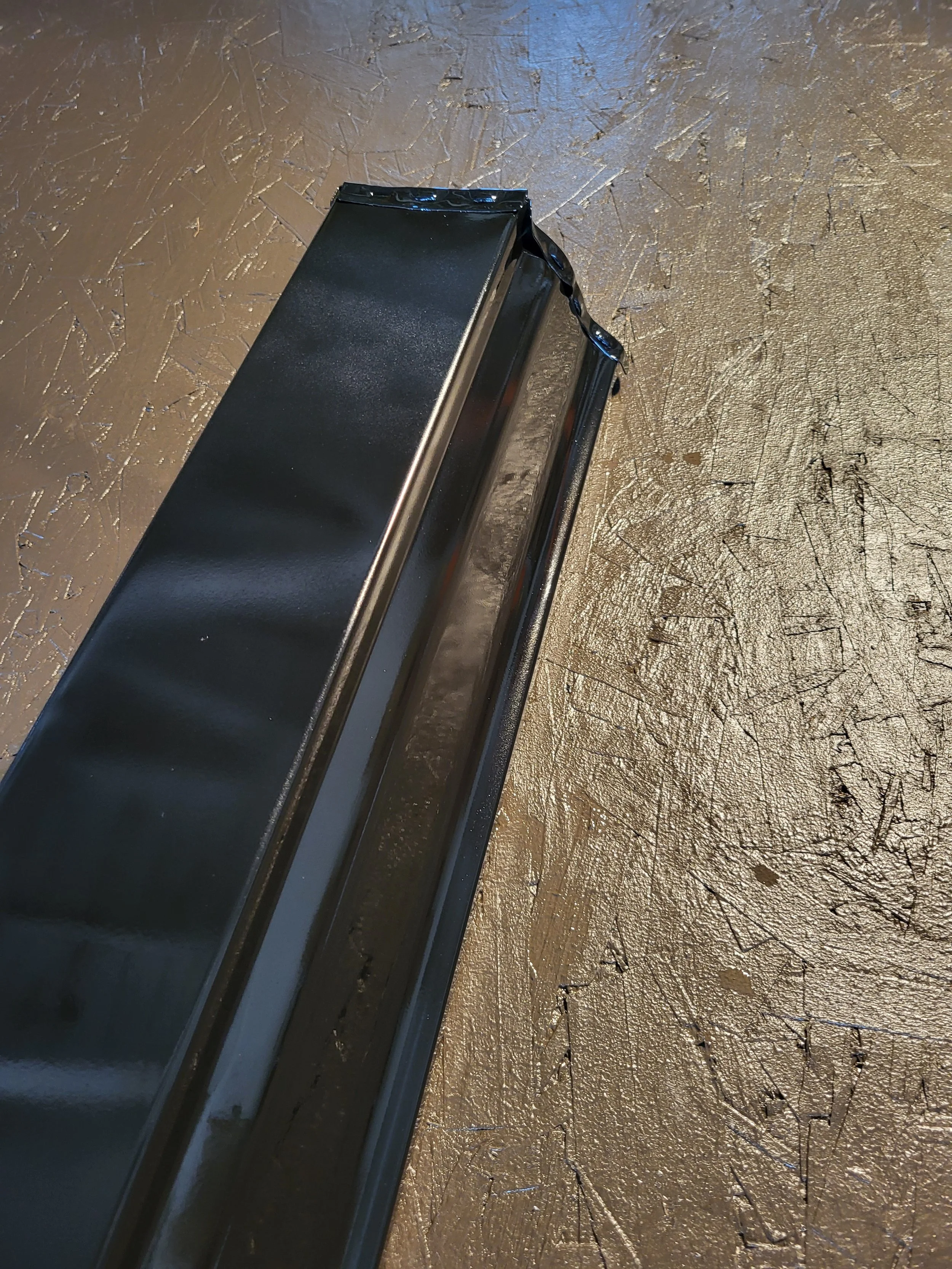 closeup of a black 5 inch k style gutter from below