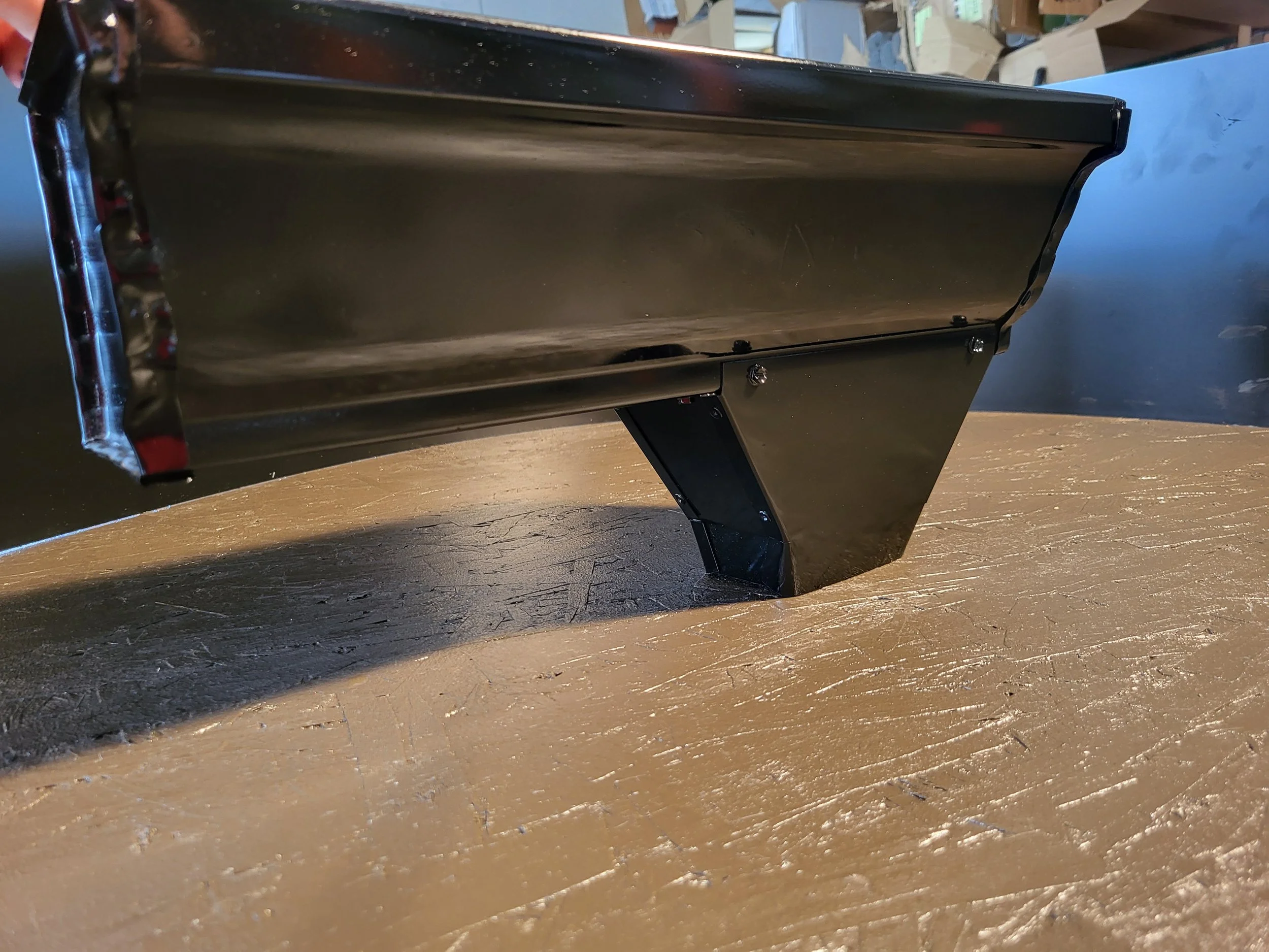 A black 6k gutter with an oversize outlet installed