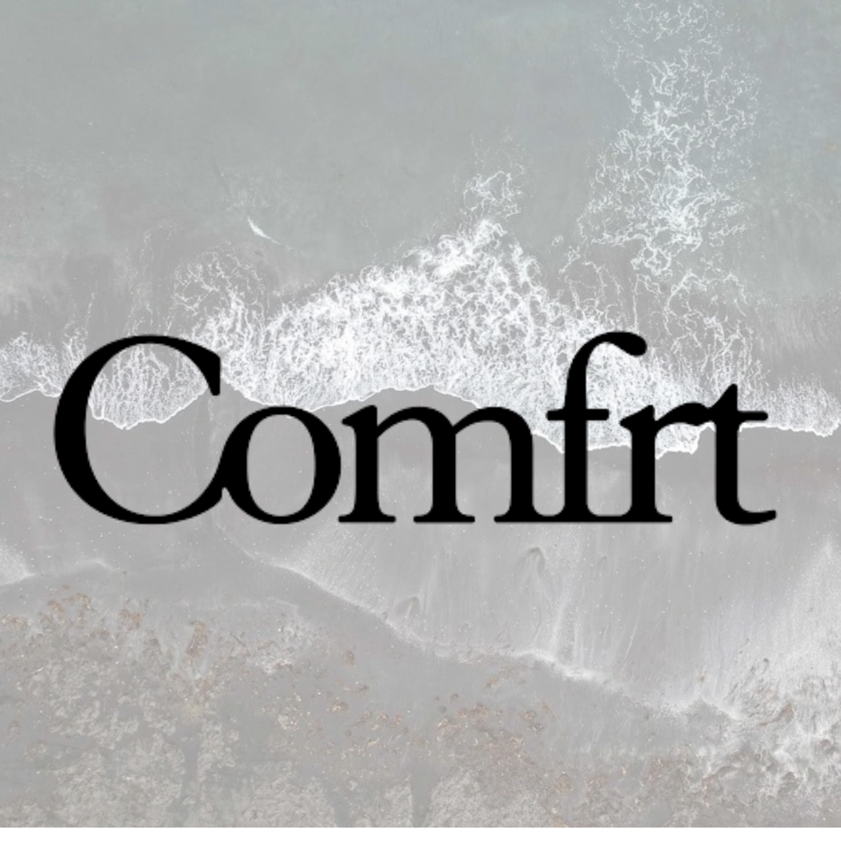 Aerial view of a beach showing waves crashing onto the shoreline with the word 'Comfort' overlaid in large black text.