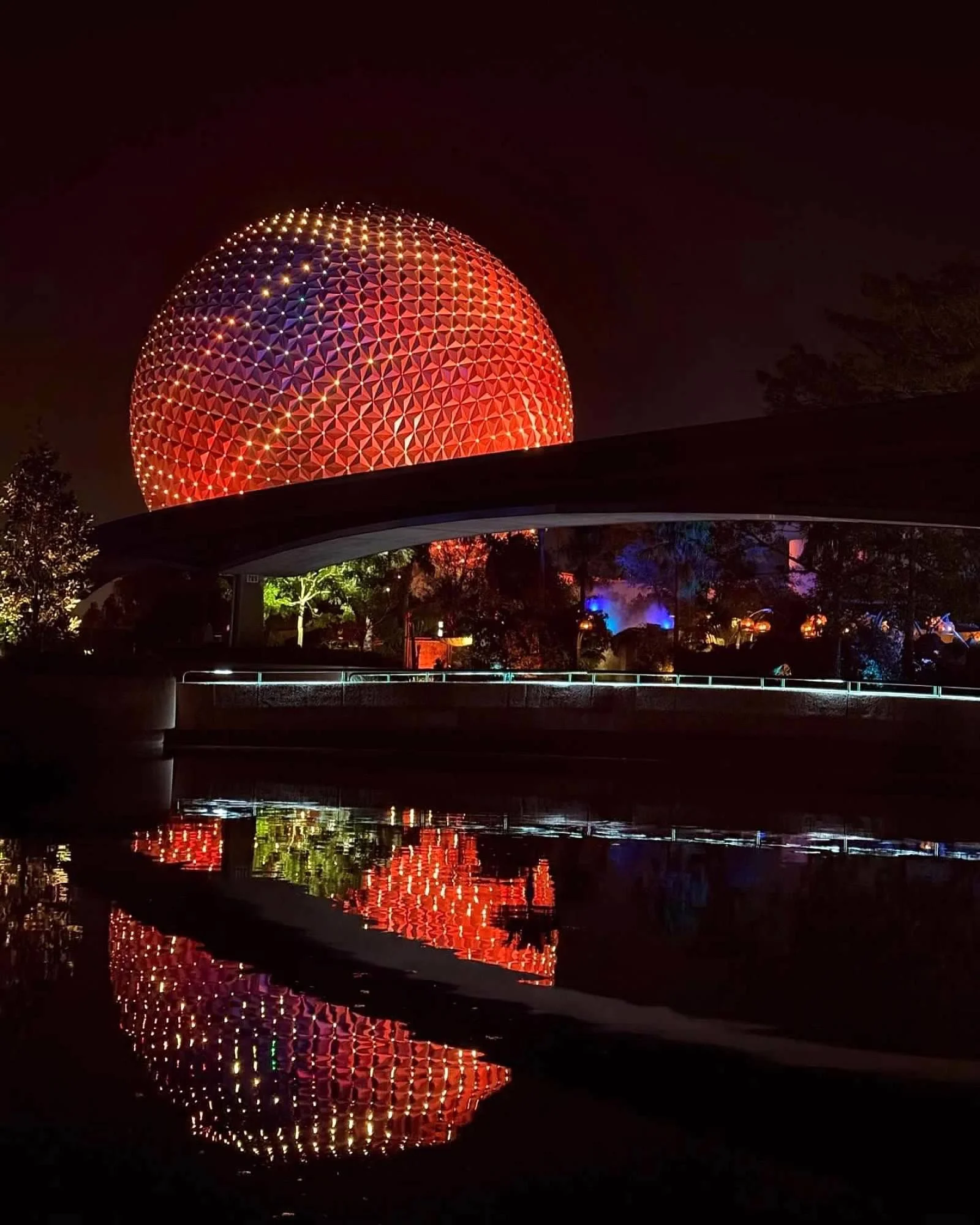 Epcot lit up at night.