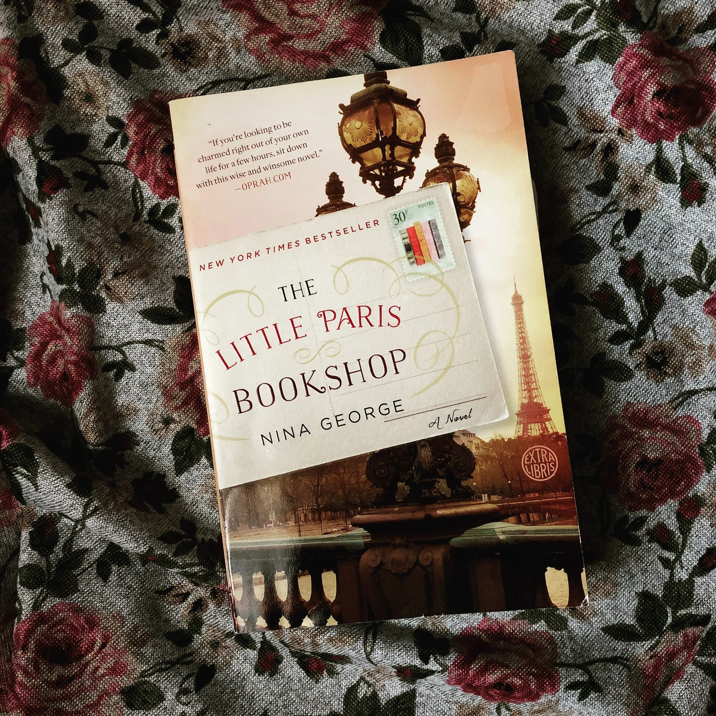 the little paris bookshop book on a floral cloth background
