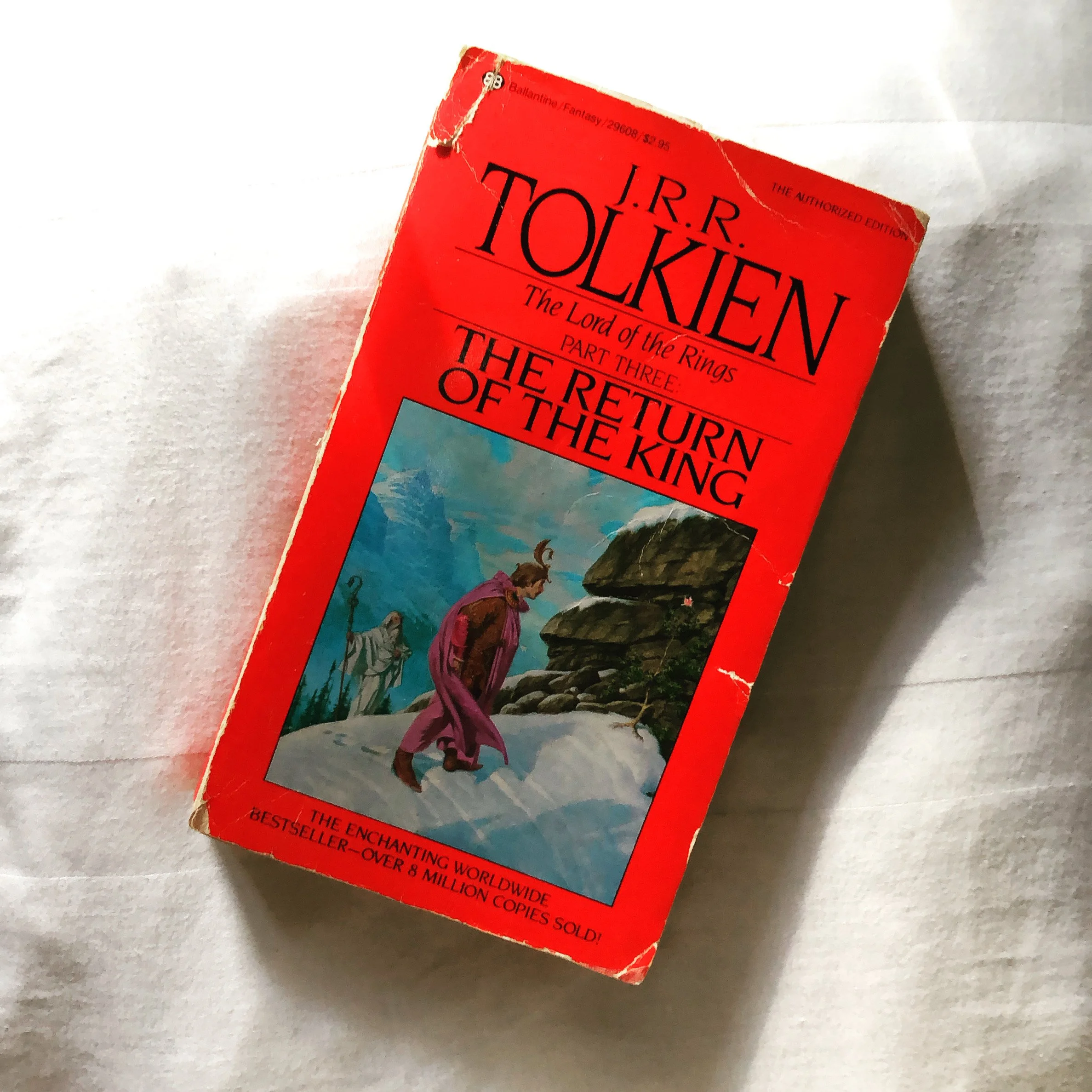 The mass market paperback cover of J.R.R. Tolkien's The Return of the King. Red background with illustration from the book
