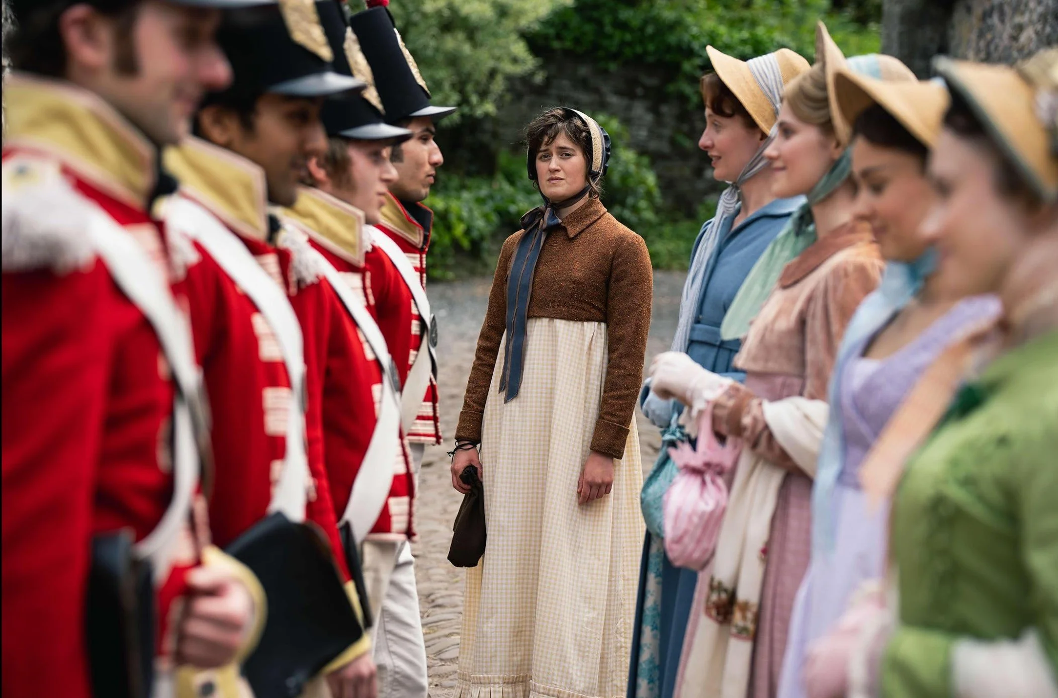 Mary and the other Bennet Sisters talking to soldiers