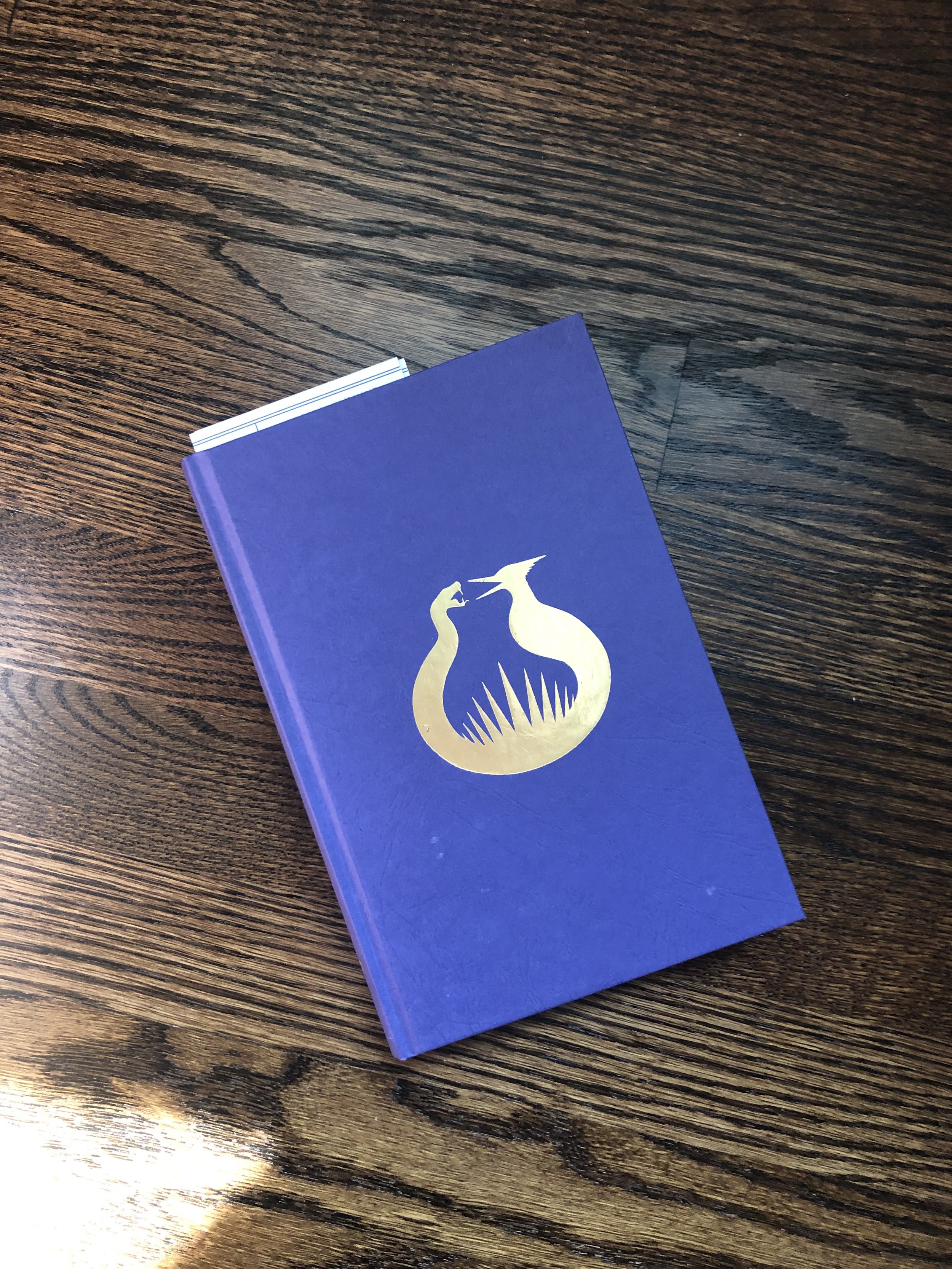 the purple and gold cover of Suzanne Collins's book Sunrise on the Reaping