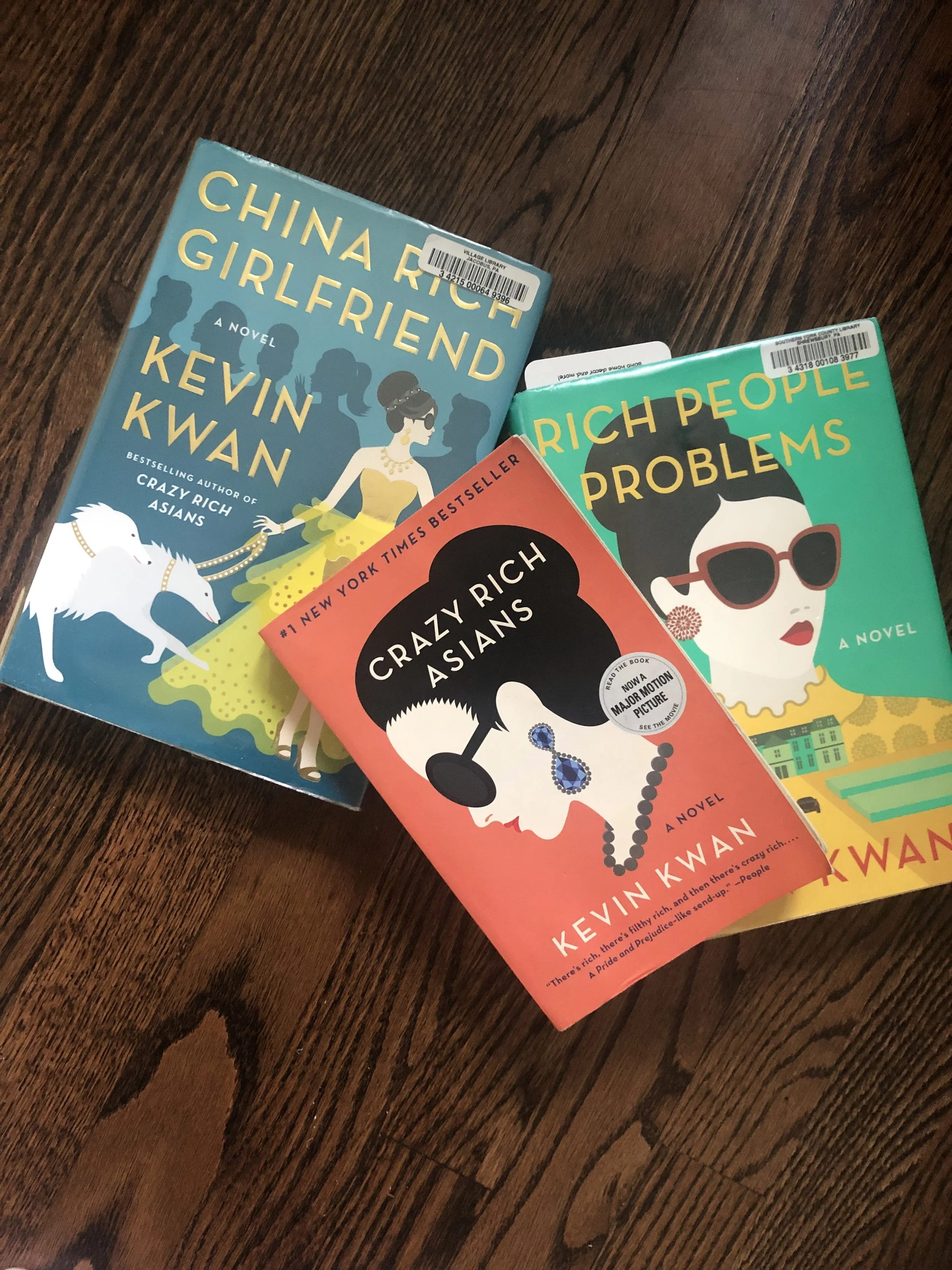 flatlay of the Crazy Rich Asians books on a wood background