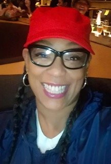 A smiling practice manager in an office setting.