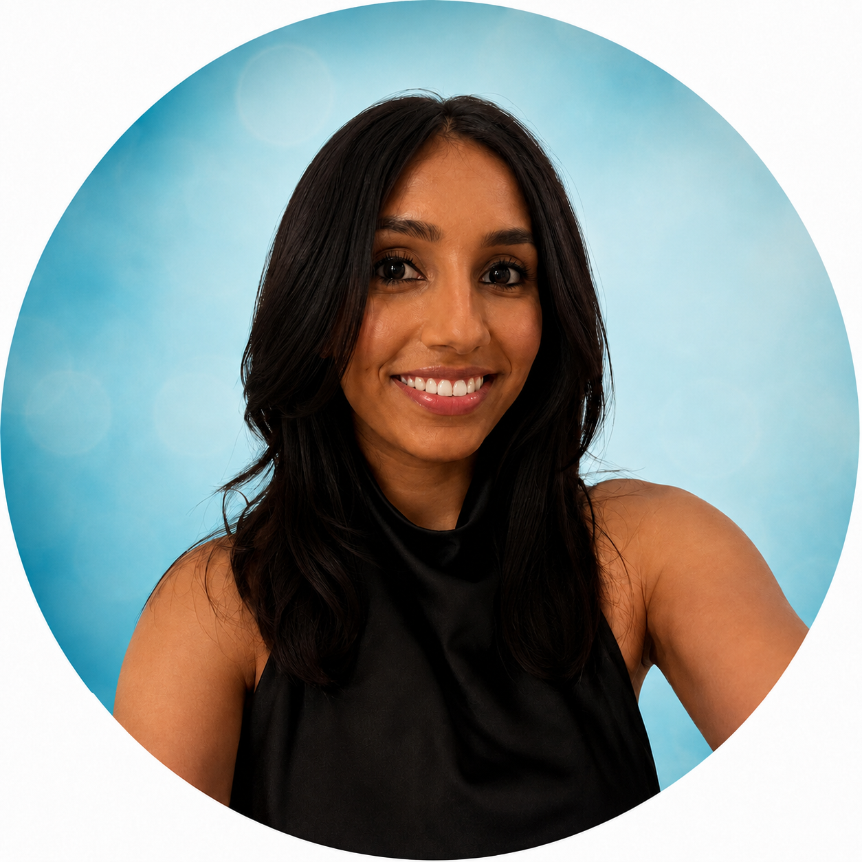 Young medical assistant with long black hair smiling at the camera in an office setting.