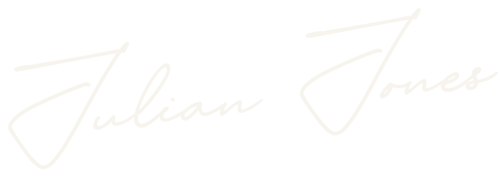Signature of Julian Jones in white cursive on a black background.