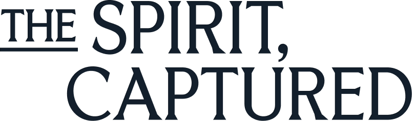 Text reading 'The Spirit, Captured' in stylized dark blue font on a white background.