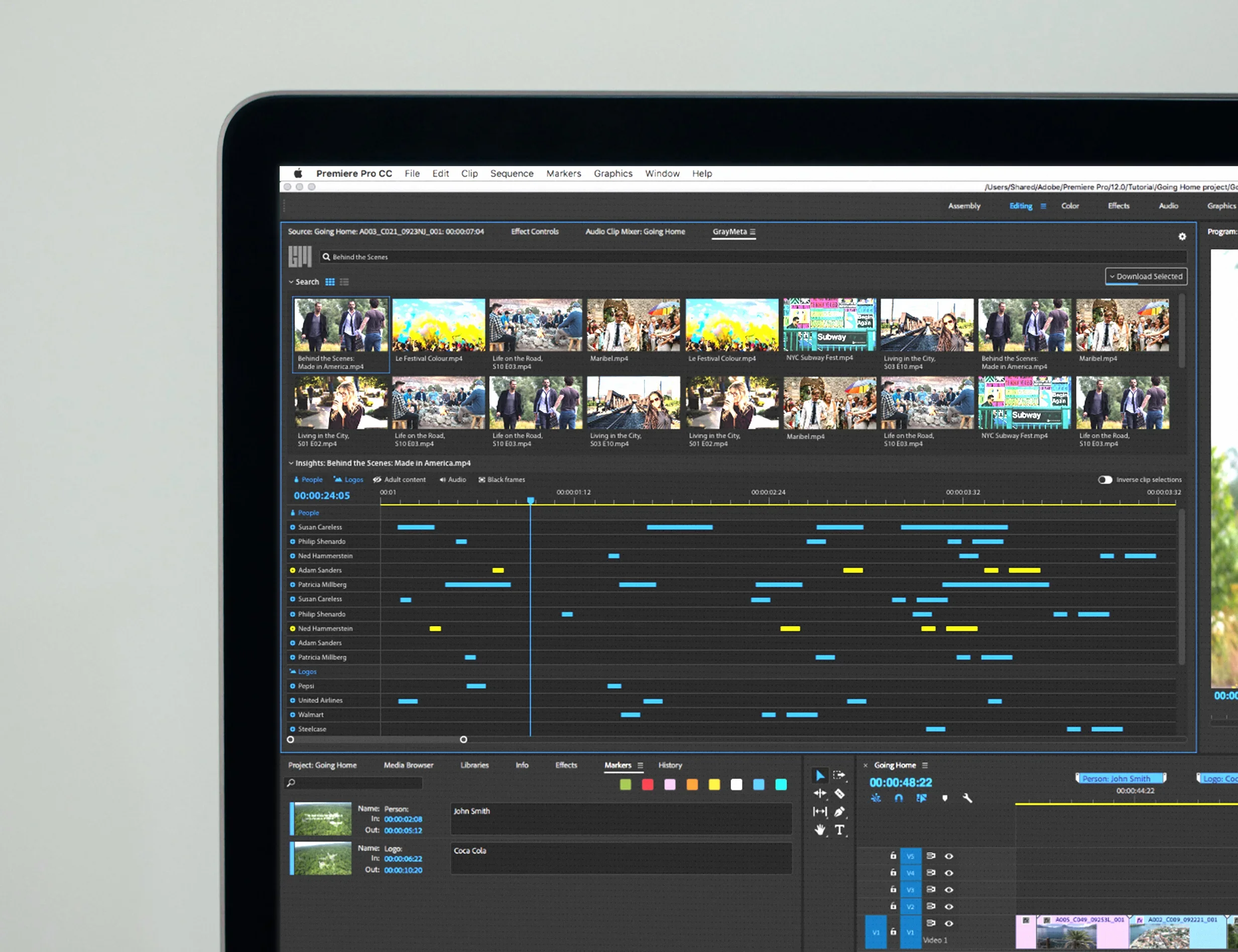 Computer monitor showing a video editing software interface with clips, timeline, and color-coded markers.