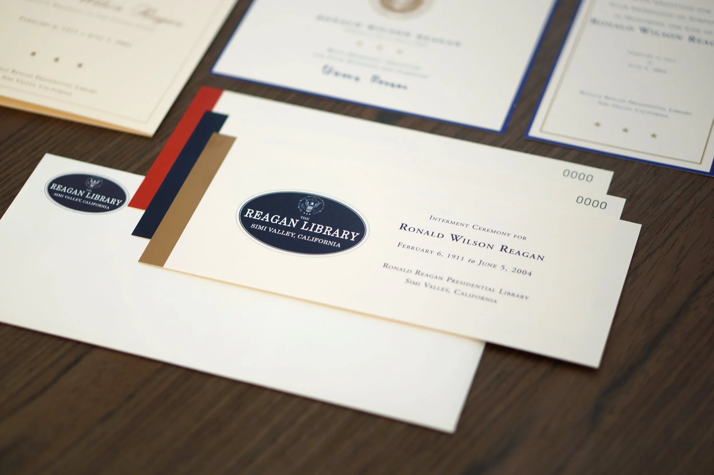 Various certificates and documents laid out on a wooden surface, some with official seals and signatures.