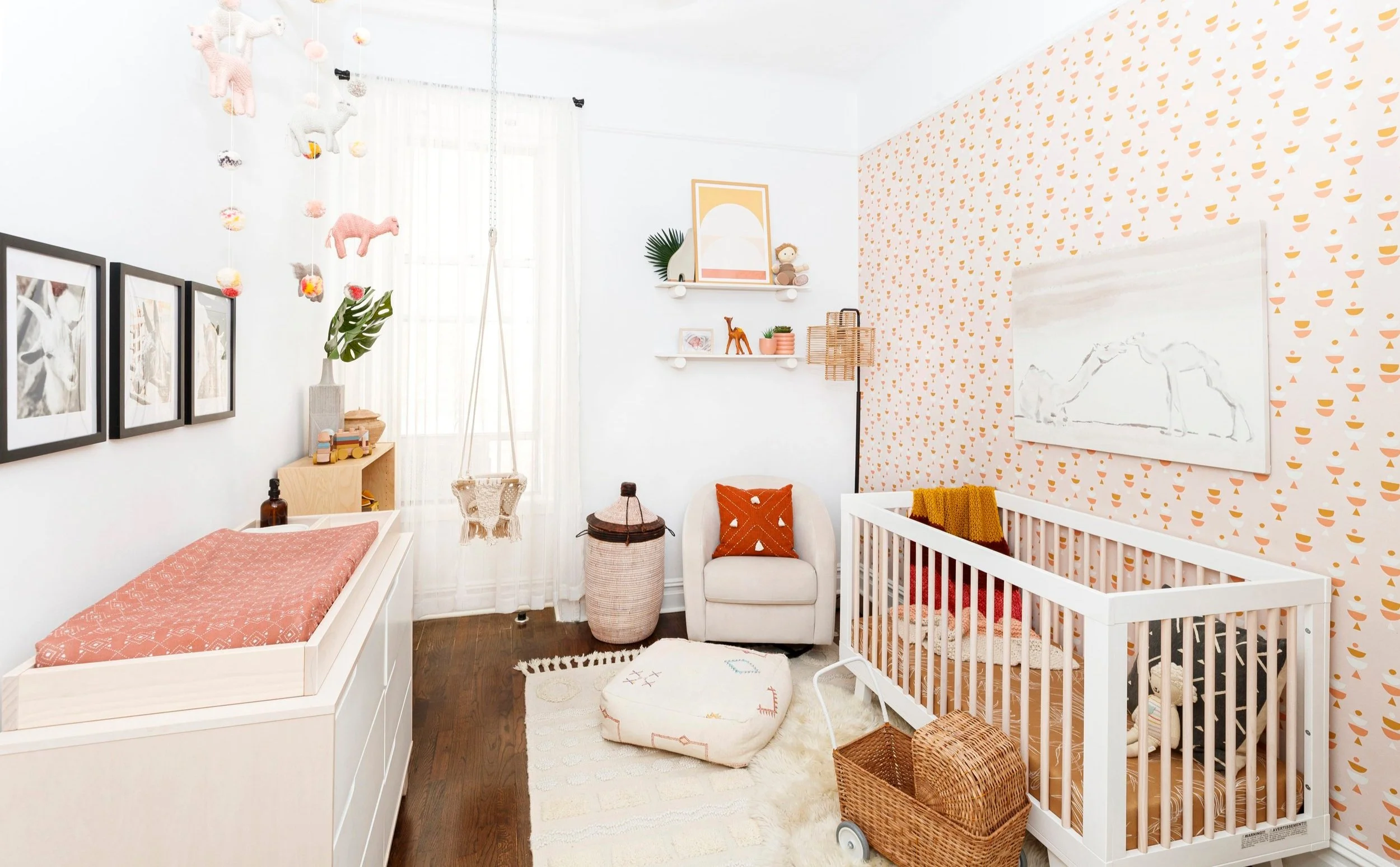 pink and rust modern moroccan themed baby girl nursery with rattan and pale wood accents designed by Westchester interior decorator Jordana Ross Interiors.