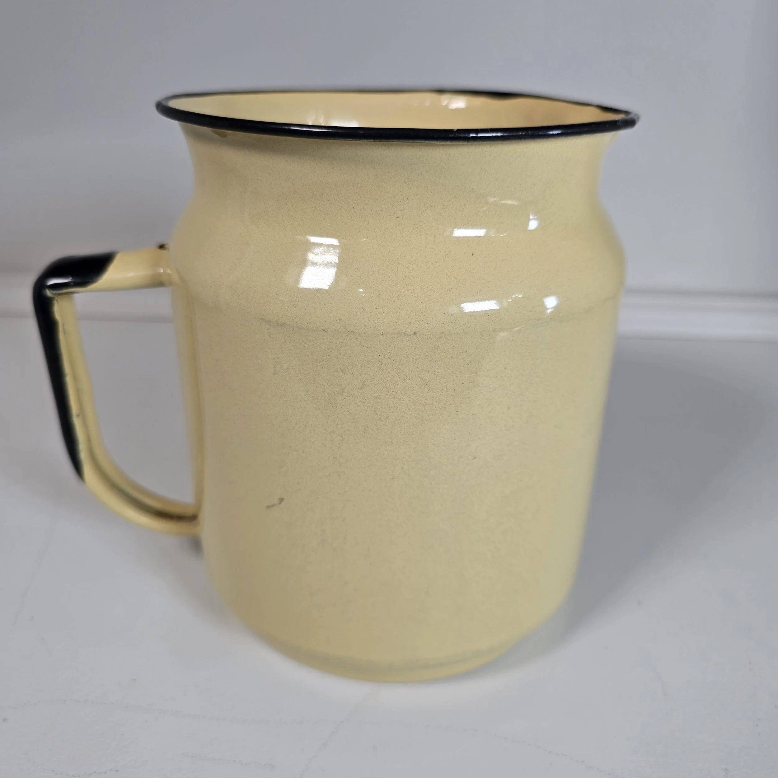 Yellow enamelware pitcher.  $40