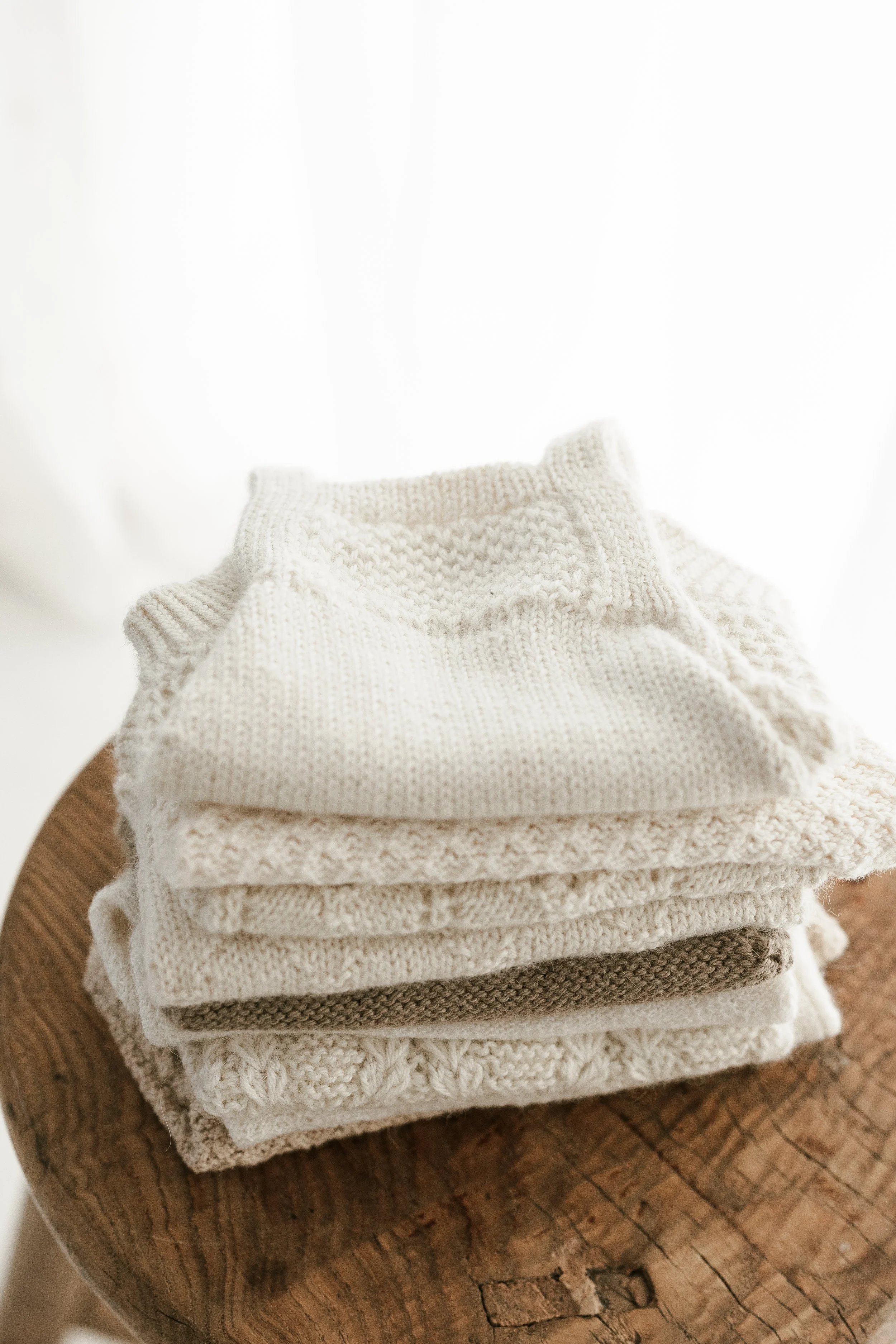 Newborn baby rompers on a stool