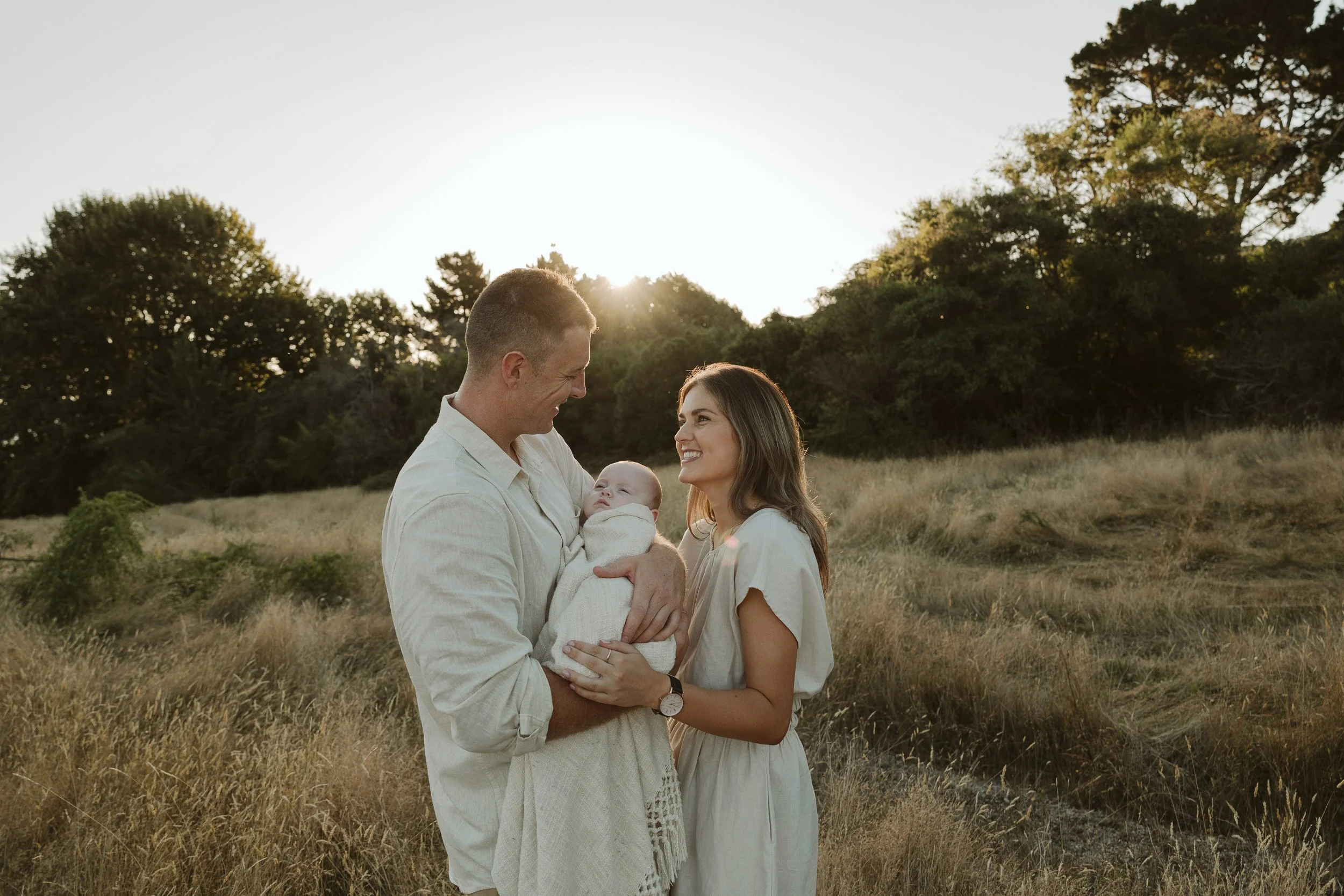 mum & dad with baby boy in field