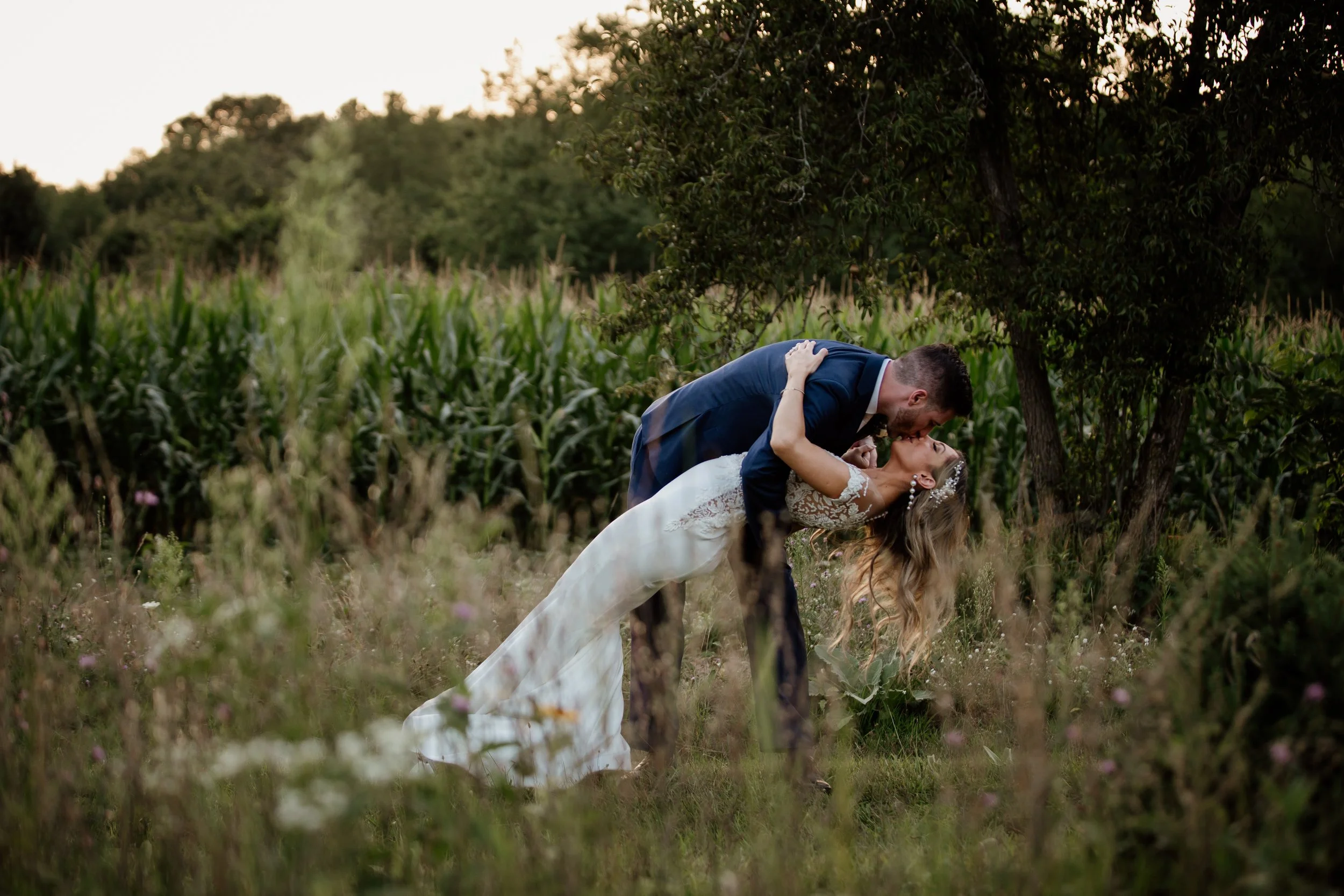 Wedding couple dip kissing at Bay Pointe Woods in Michigan