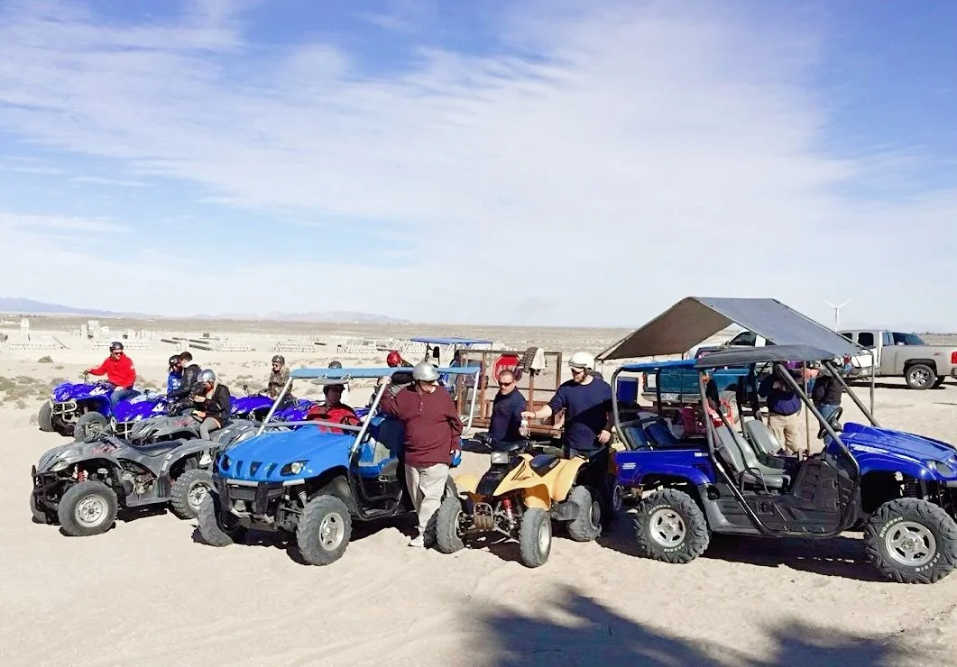 People on ATVs and side-by-sides in desert area