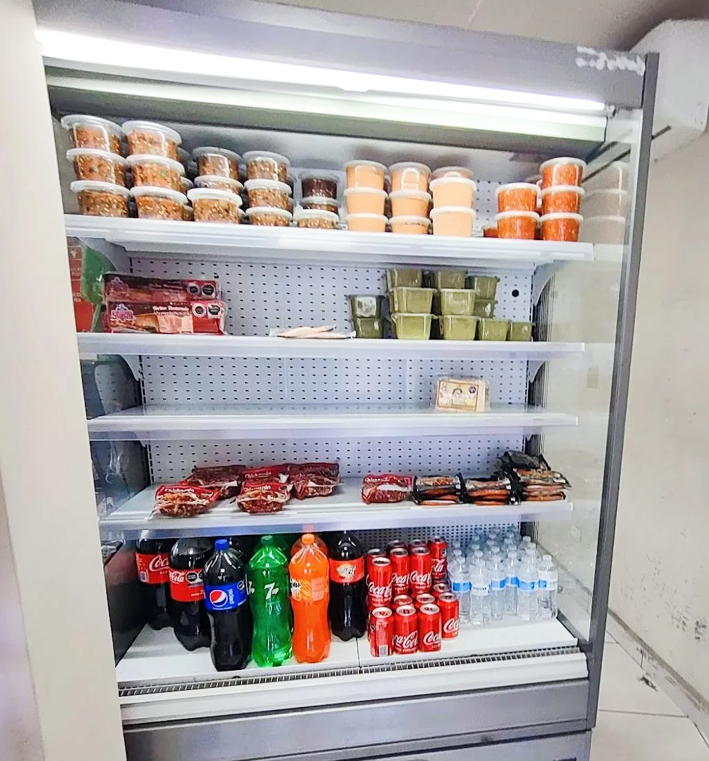 Stocked refrigerator with packaged food and drinks
