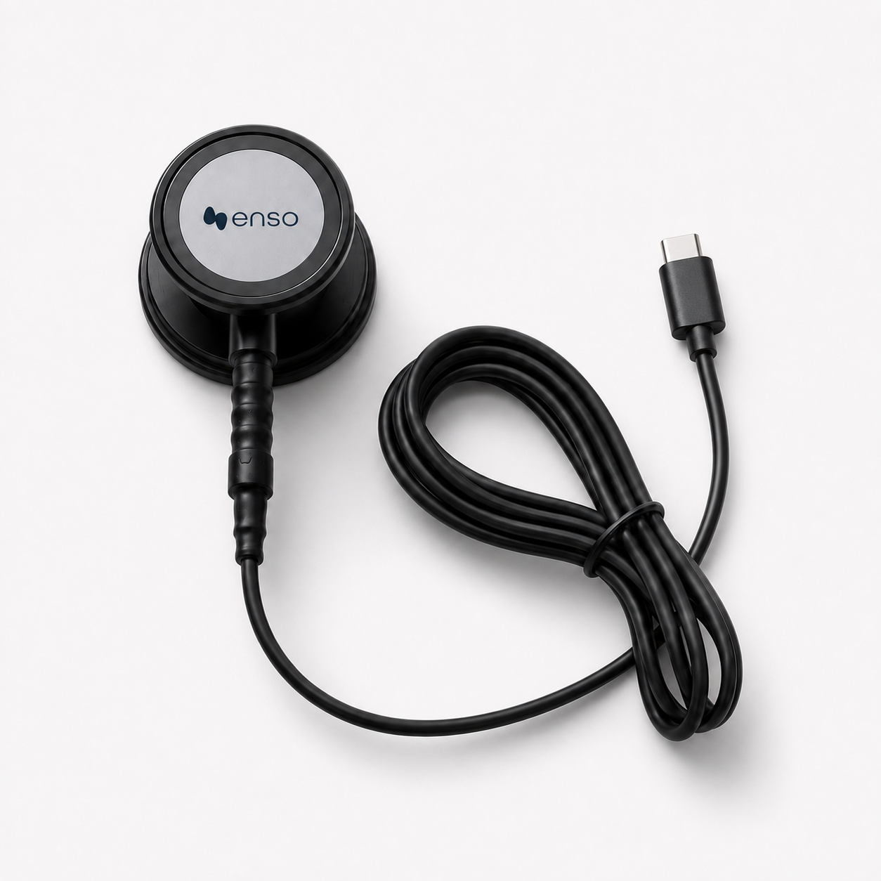 A black Enso blood pressure cuff with a coiled hose and a USB-C connector on a white background.