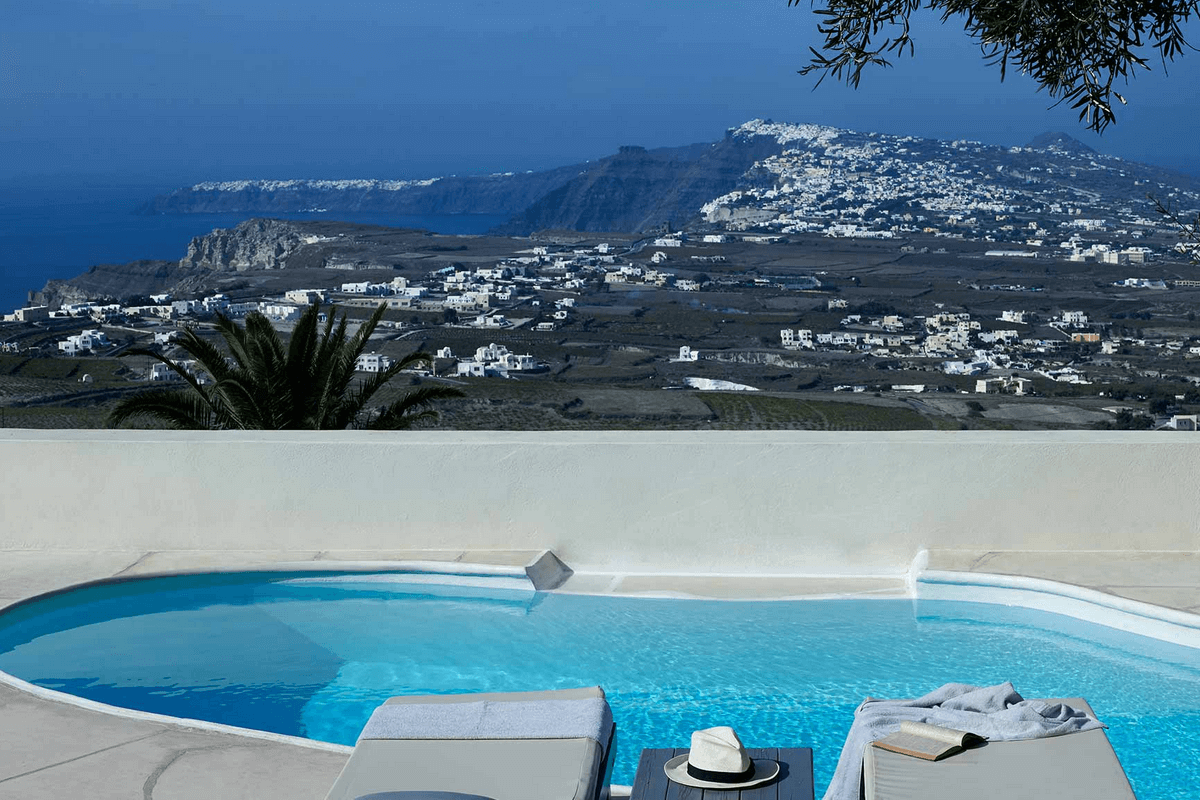 Luxurious suite with private pool and Caldera views at Zannos Melathron Hotel, a 19th-century mansion in Pyrgos, Santorini, offering historic charm and modern comforts.